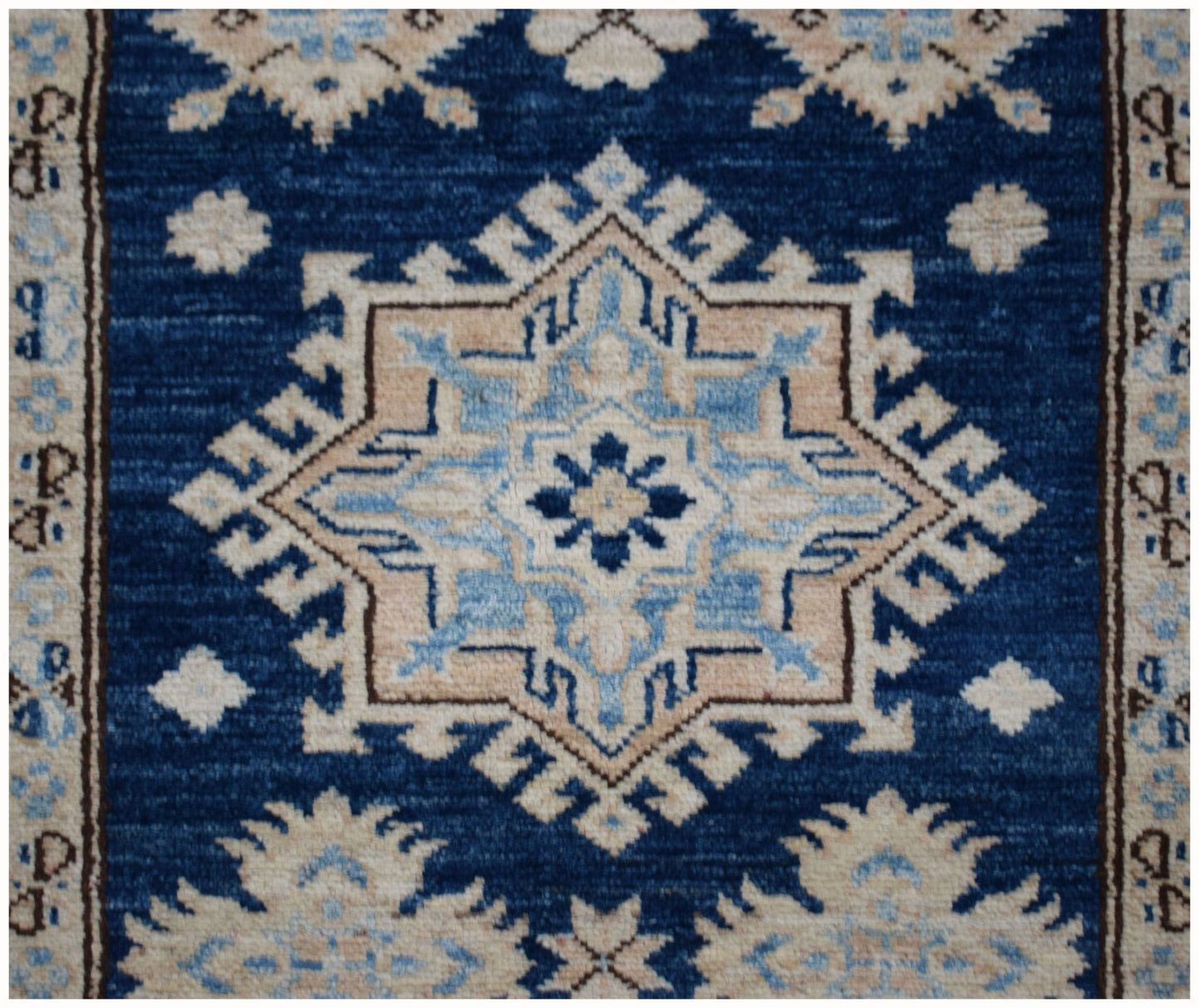 An Afghan Super Kazakh runner rug featuring a geometric star medallion in blue and beige tones.
