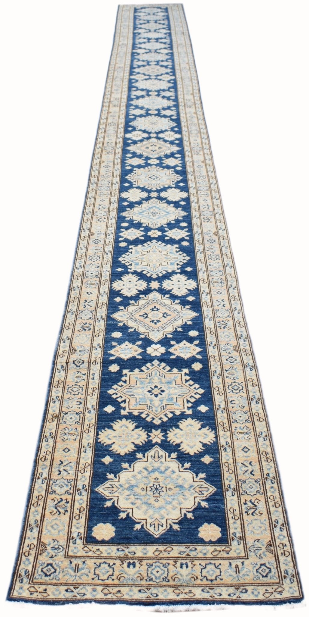 An Afghan Super Kazakh runner rug featuring a blue field with geometric beige and grey patterns.