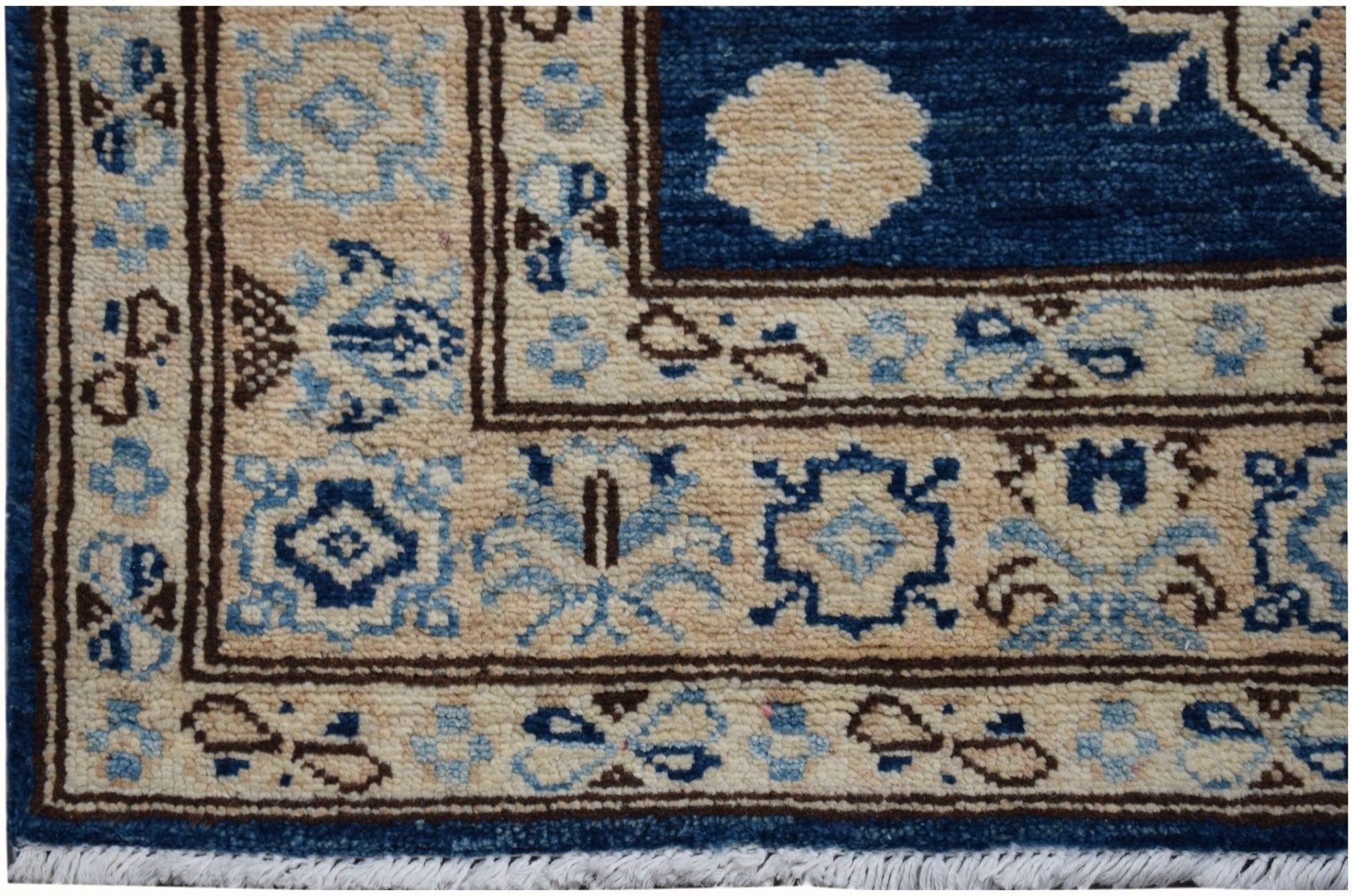 A handmade Afghan Super Kazakh runner rug featuring a beige border with blue and brown patterns.