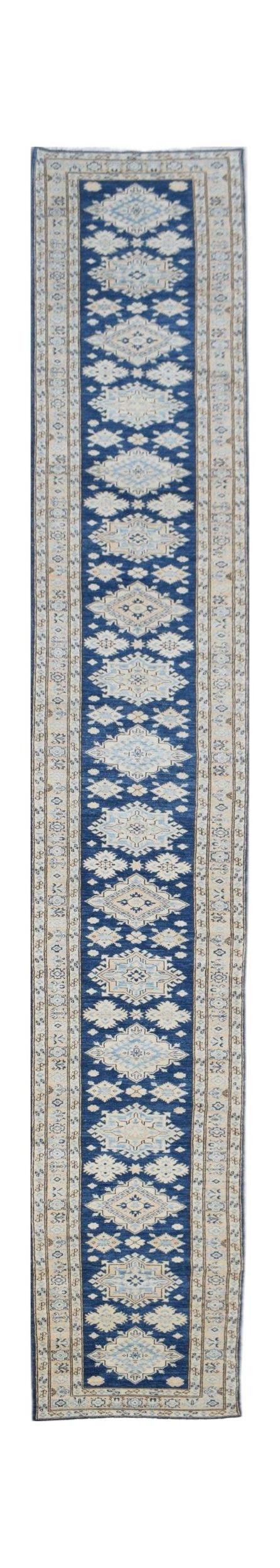 A long, handmade Afghan Super Kazakh runner rug featuring a repeating geometric pattern in blue.