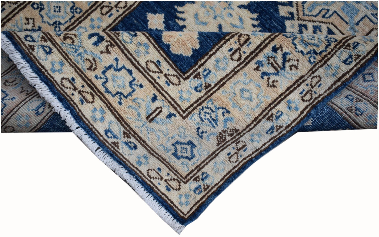 A handmade Afghan Super Kazakh runner featuring a geometric pattern in blue, beige, and grey.