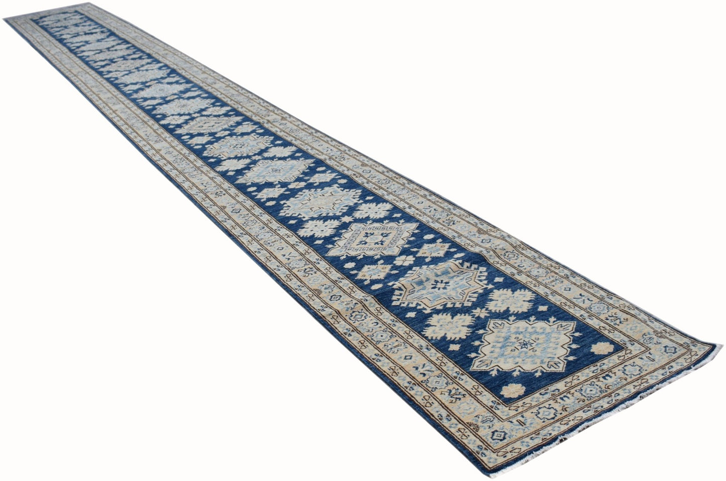 A long, handmade Afghan Super Kazakh runner rug featuring a blue field with beige geometric motifs.