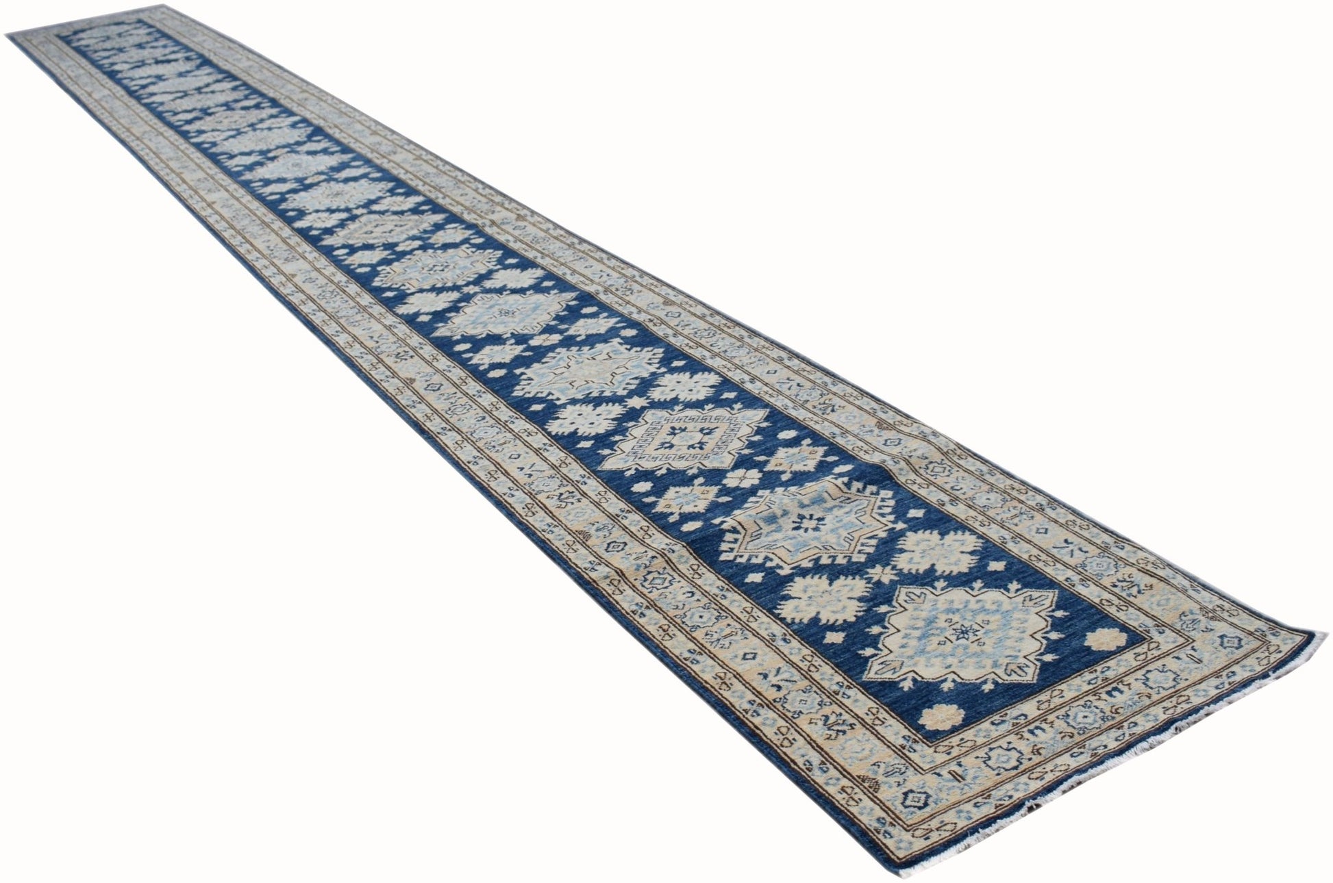 A long, handmade Afghan Super Kazakh runner rug featuring a blue field with beige geometric motifs.
