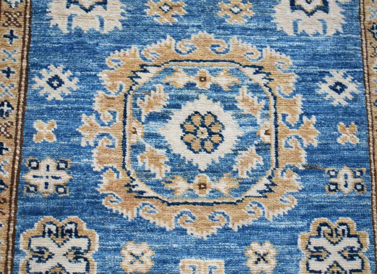 Handmade Afghan Super Kazakh runner rug featuring traditional blue and beige geometric motifs.