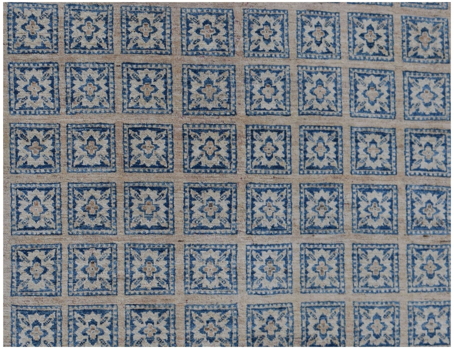 Handmade Afghan Chobi rug featuring a repeating grid of blue and beige floral square motifs.