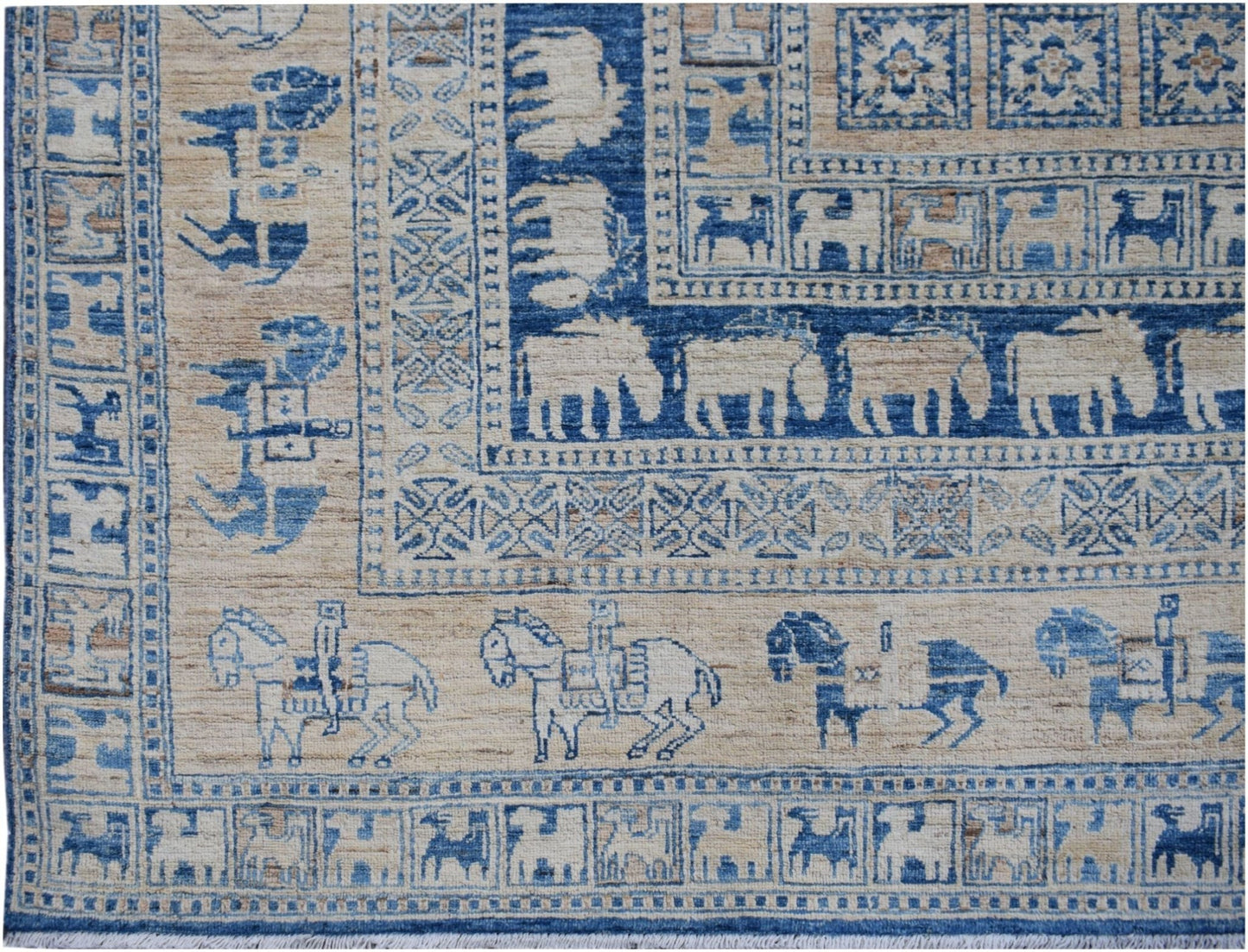 Handmade Afghan Chobi rug featuring blue and beige geometric patterns and animal motifs.