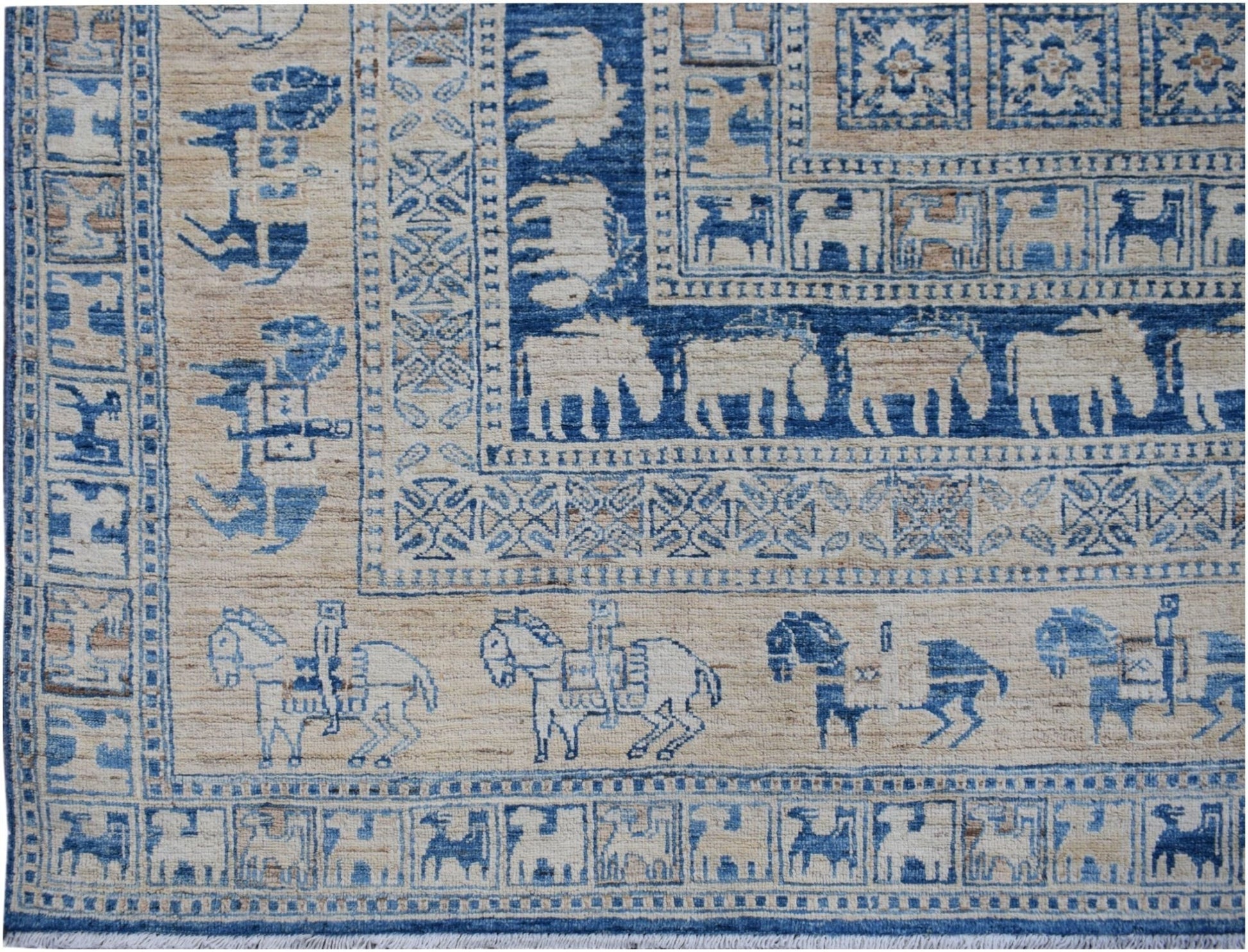 Handmade Afghan Chobi rug featuring blue and beige geometric patterns and animal motifs.
