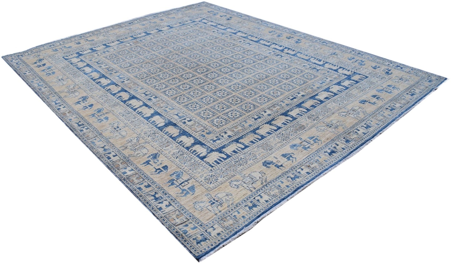 A handmade Afghan Chobi rug featuring a blue and beige Pazyryk pattern with animal motifs.