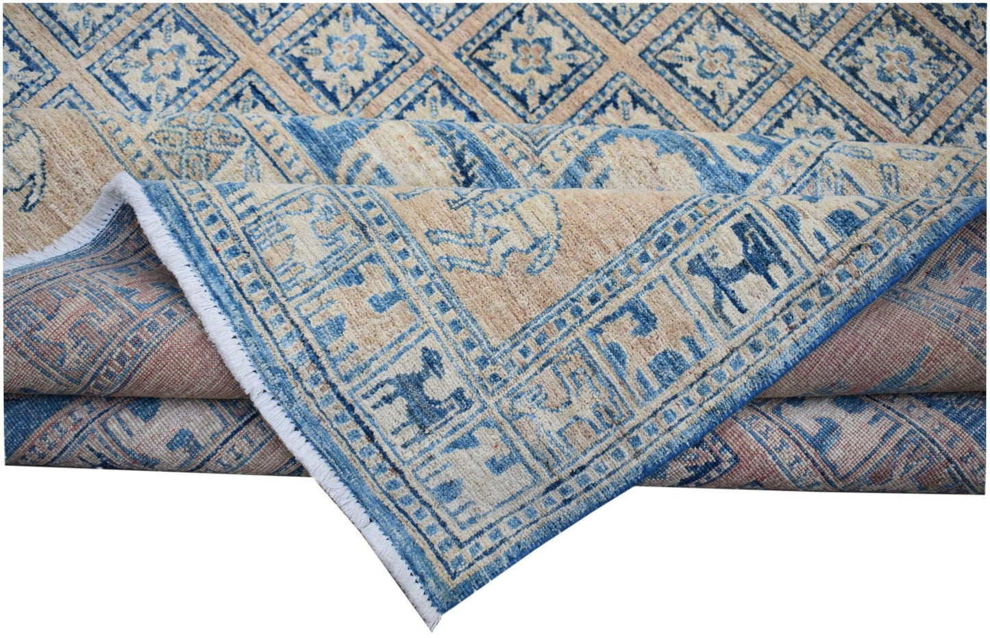 A handmade Afghan Chobi rug featuring a blue and beige geometric pattern with a fringed edge.