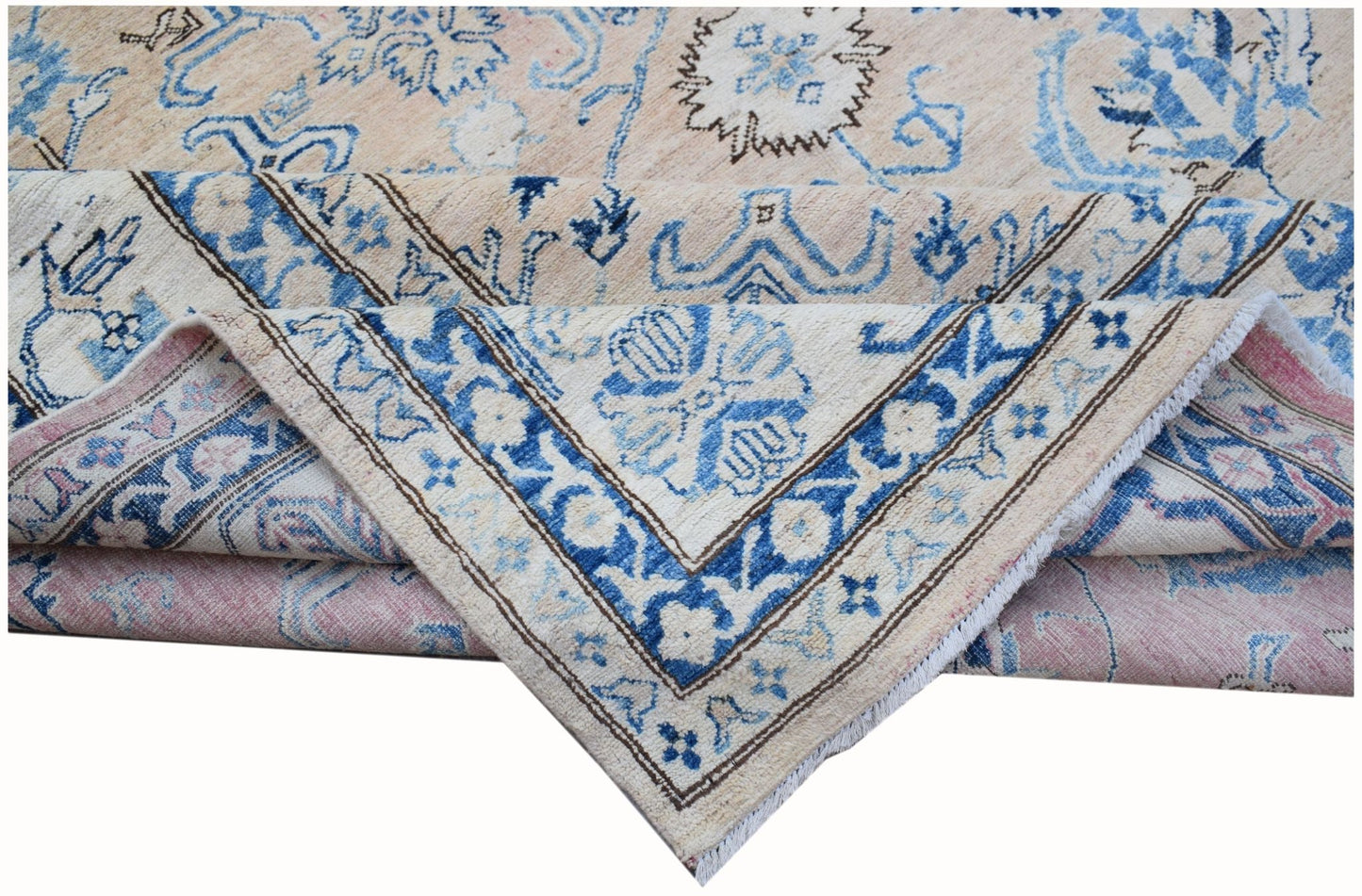A handmade Afghan Super Kazakh rug featuring a beige field with blue floral patterns.