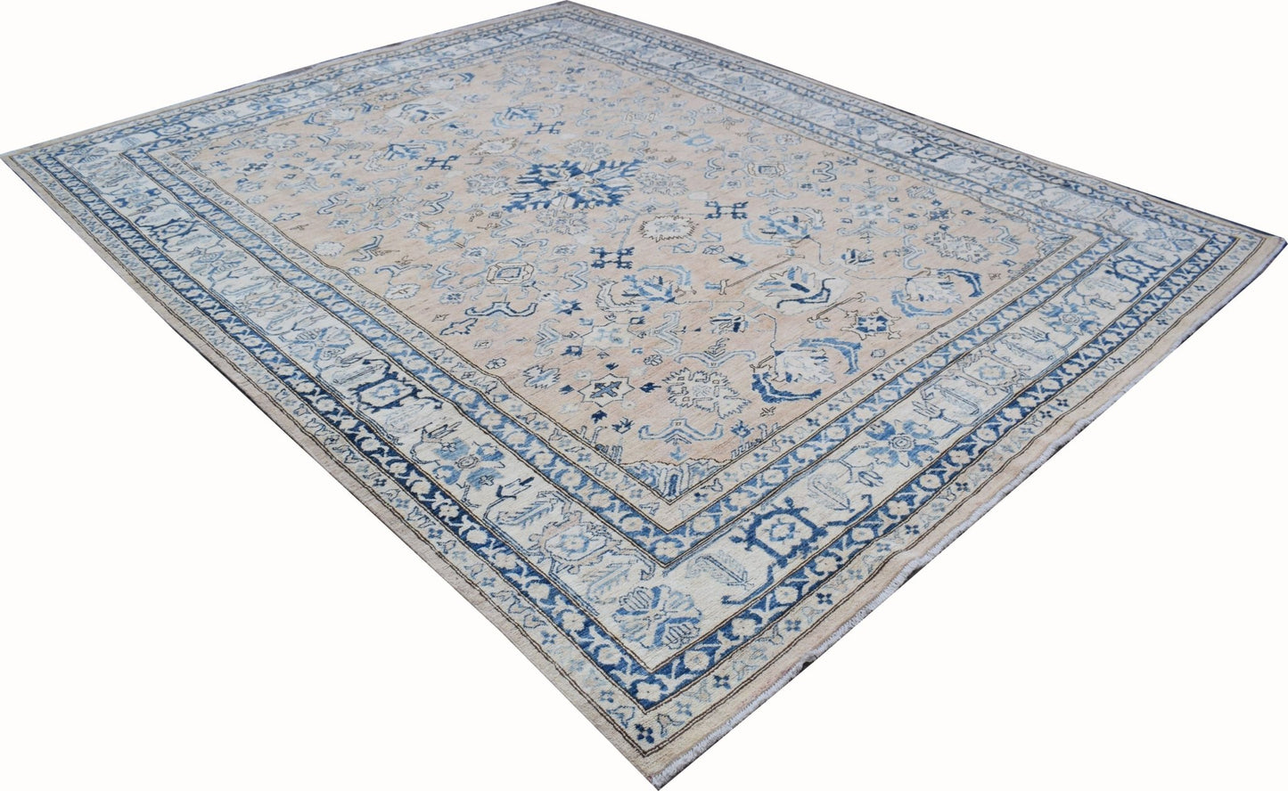 Handmade Afghan Super Kazakh rug featuring a beige field with intricate blue floral patterns.