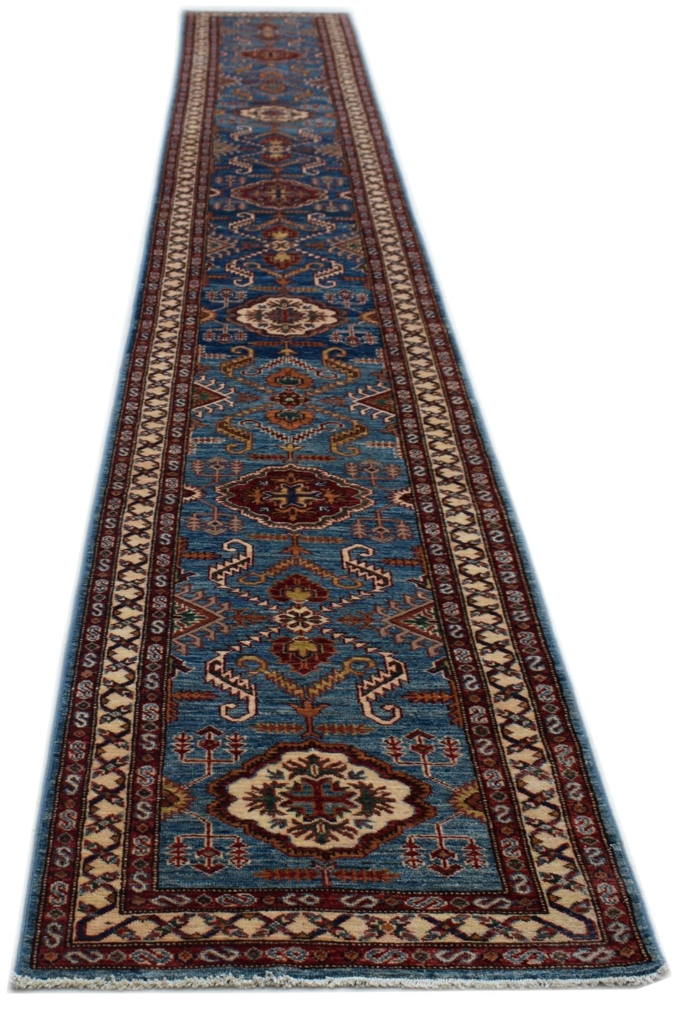 A long, handmade Afghan Super Kazakh runner rug featuring traditional geometric motifs in blue.