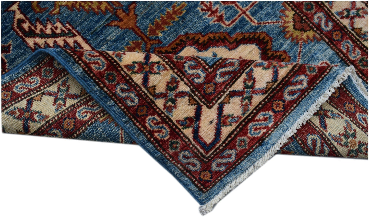 A handmade Afghan Super Kazakh runner featuring traditional geometric motifs in blue and red.