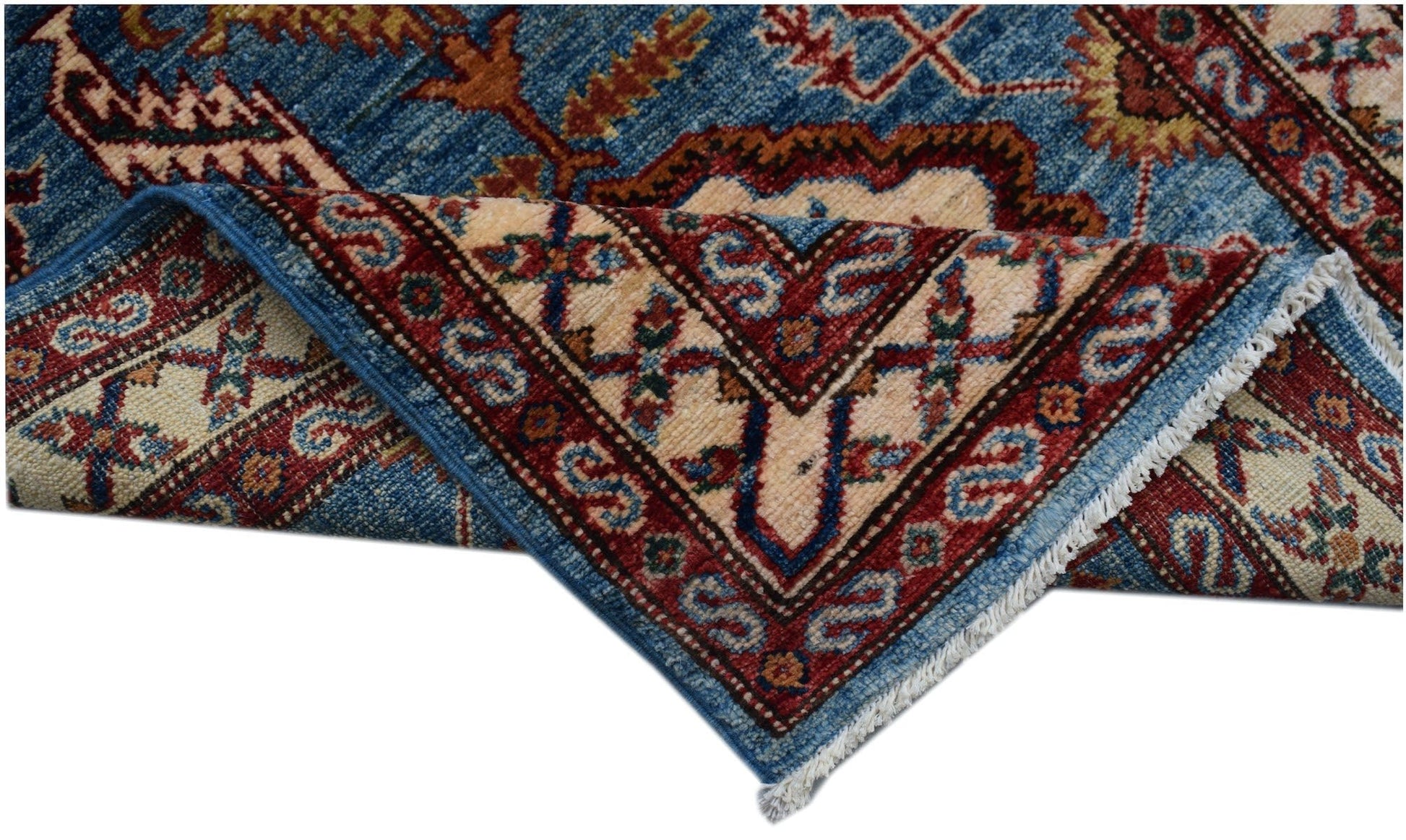A handmade Afghan Super Kazakh runner featuring traditional geometric motifs in blue and red.