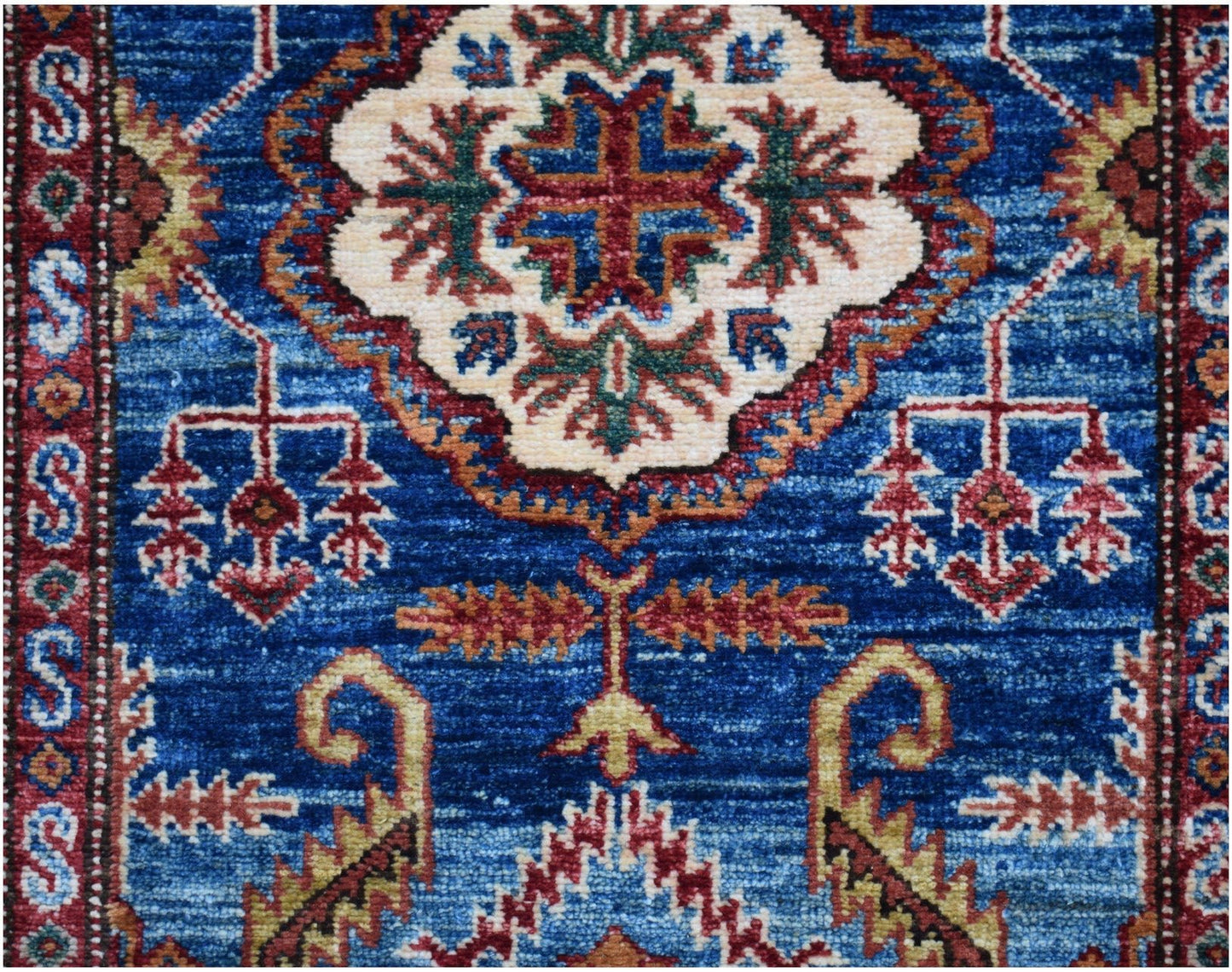 An Afghan Super Kazakh runner featuring traditional geometric motifs in blue, red, and cream.