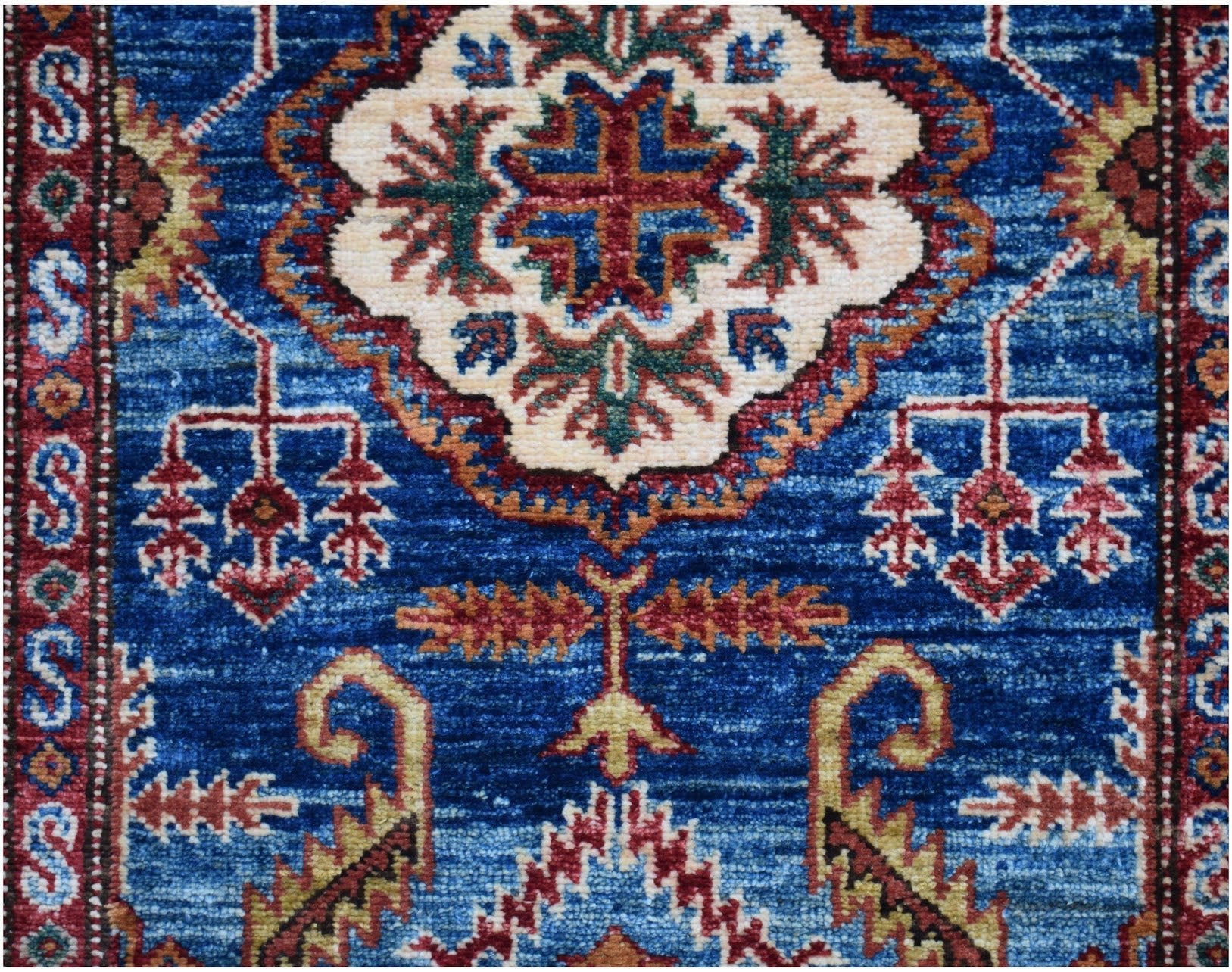 An Afghan Super Kazakh runner featuring traditional geometric motifs in blue, red, and cream.