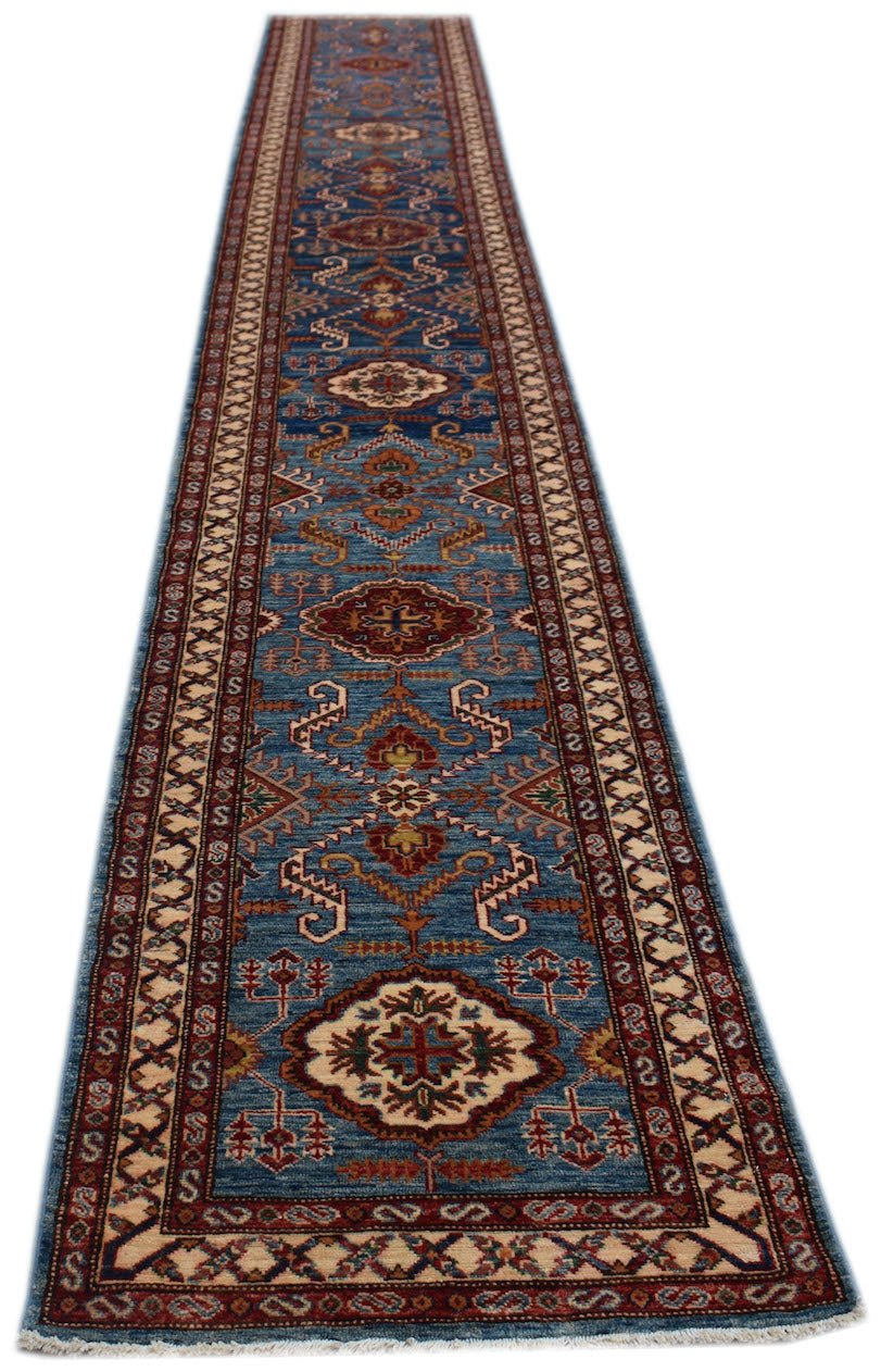A long, handmade Afghan Super Kazakh runner rug featuring traditional geometric motifs in blue.