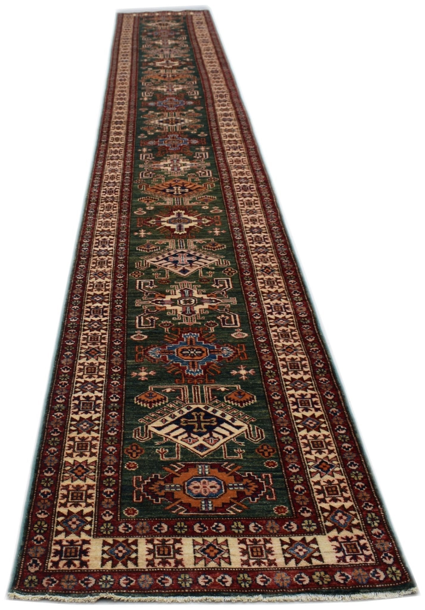An Afghan Super Kazakh runner rug featuring traditional geometric motifs in a deep green field.