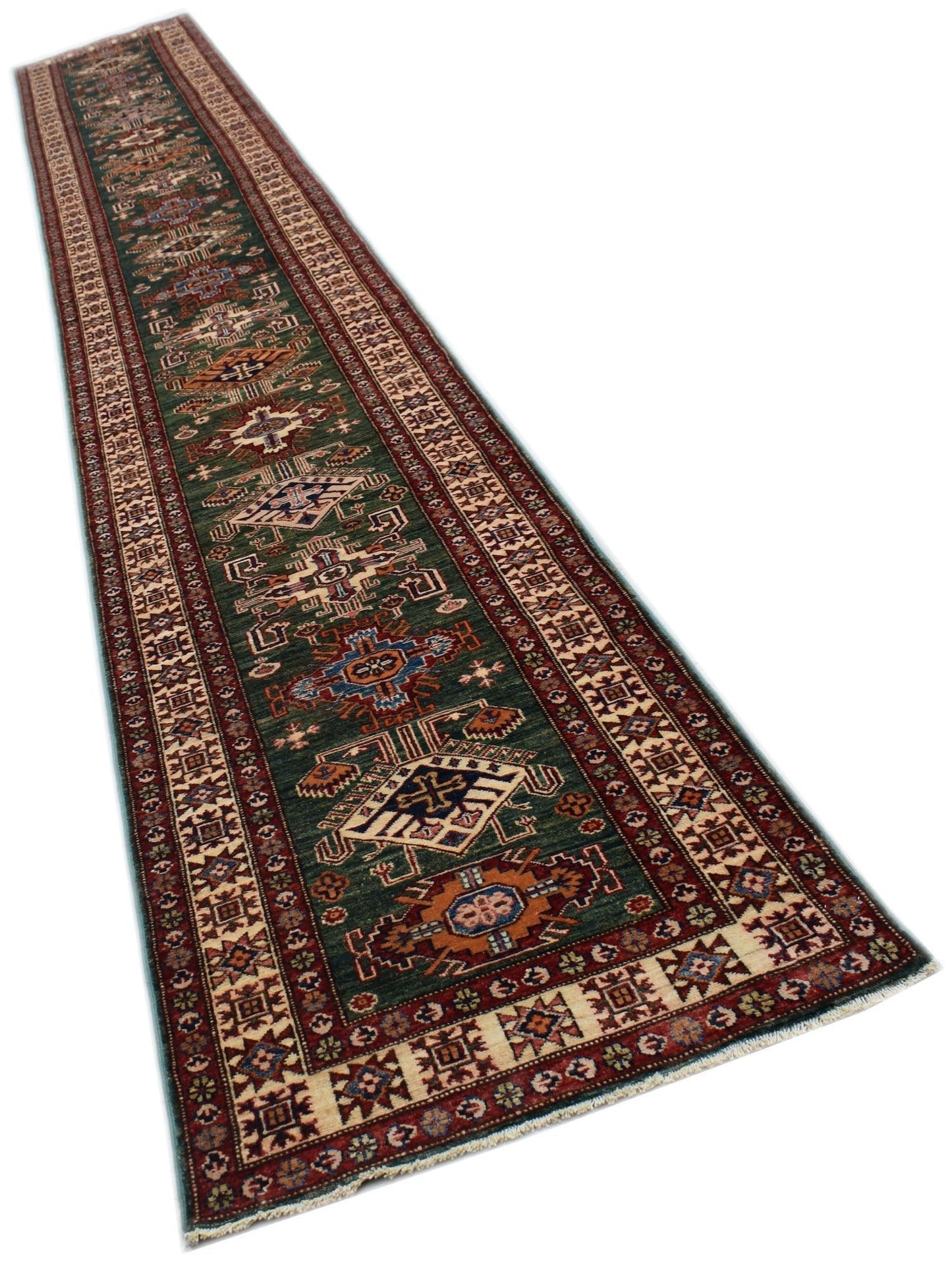 A long, handmade Afghan Super Kazakh runner rug featuring traditional geometric motifs in green.