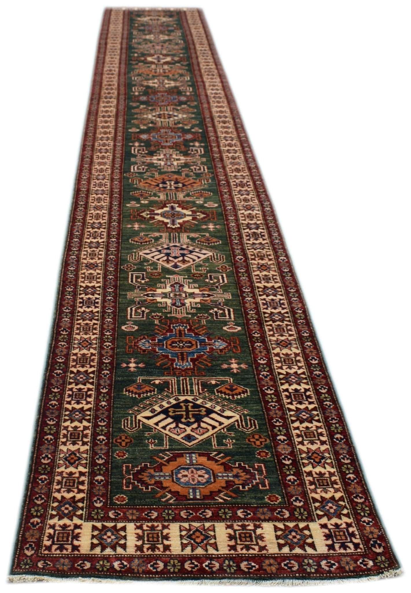 A long, handmade Afghan Super Kazakh runner rug featuring traditional geometric motifs in green.