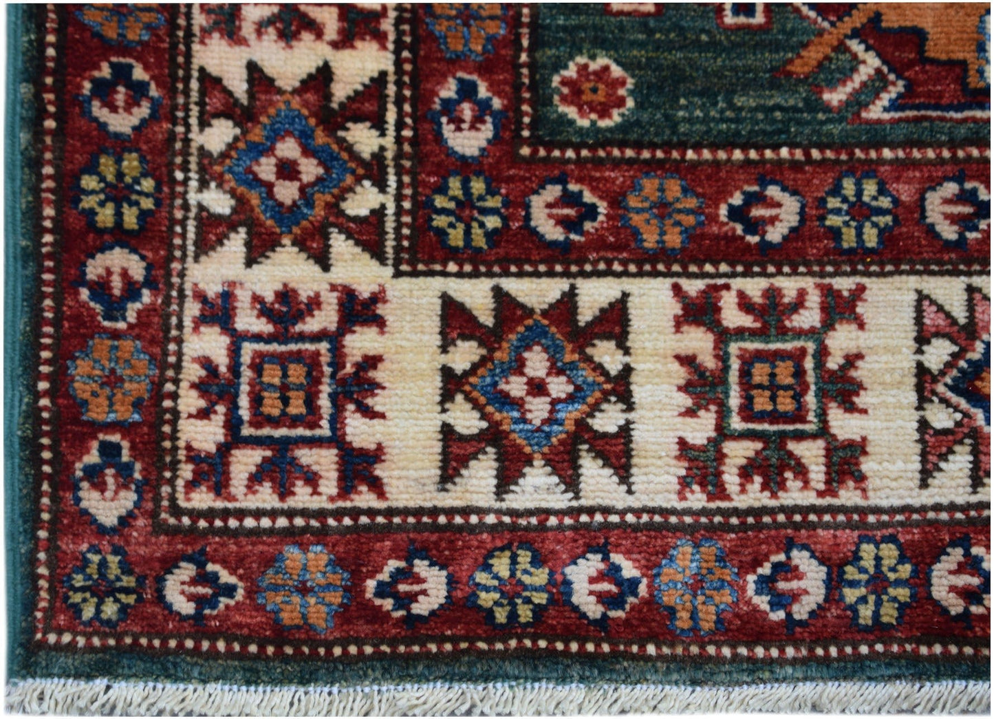 A hand-knotted Afghan Super Kazakh runner featuring traditional geometric motifs in red and cream.