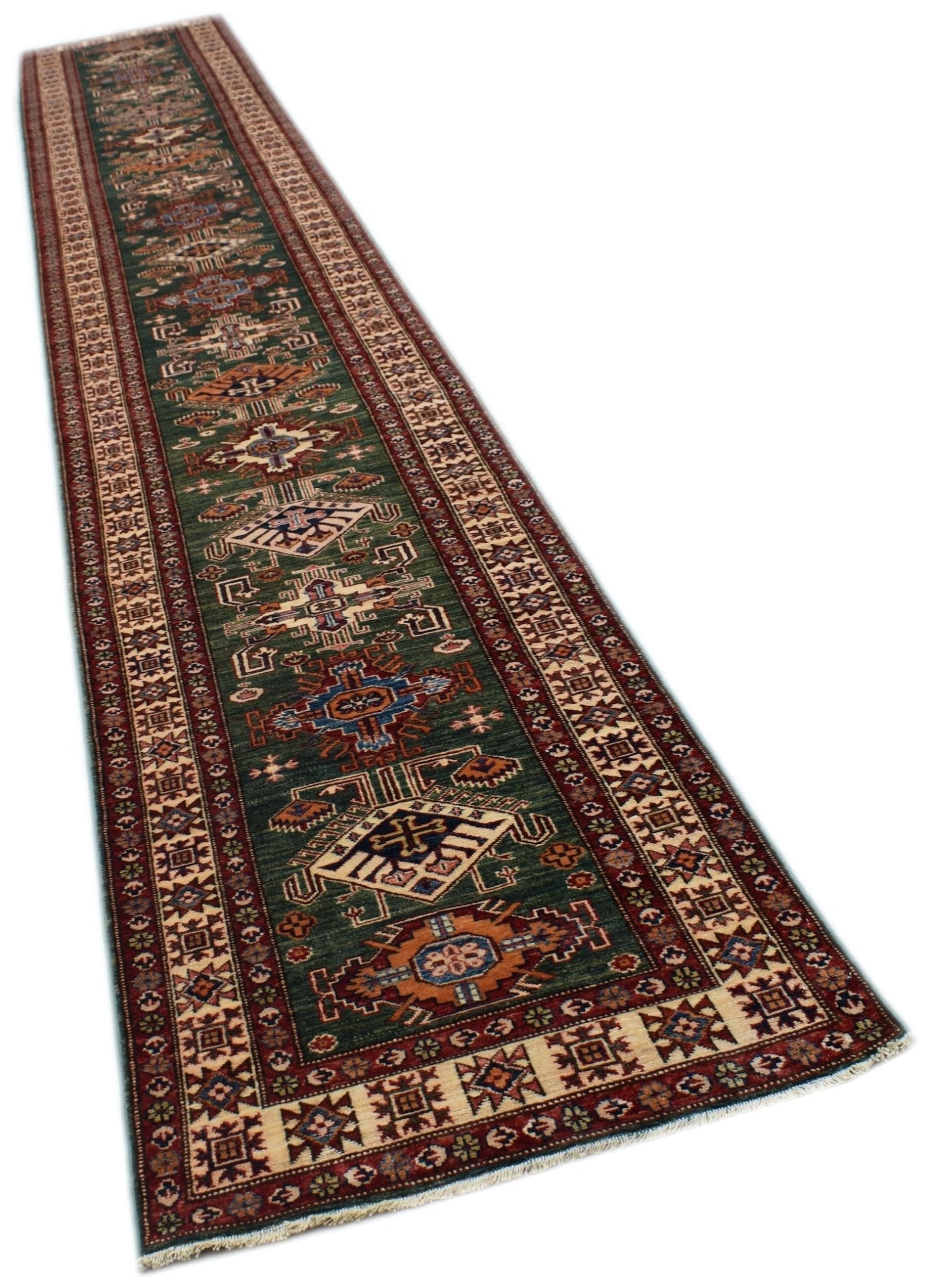 A long, handmade Afghan Super Kazakh runner rug featuring traditional geometric motifs in green.