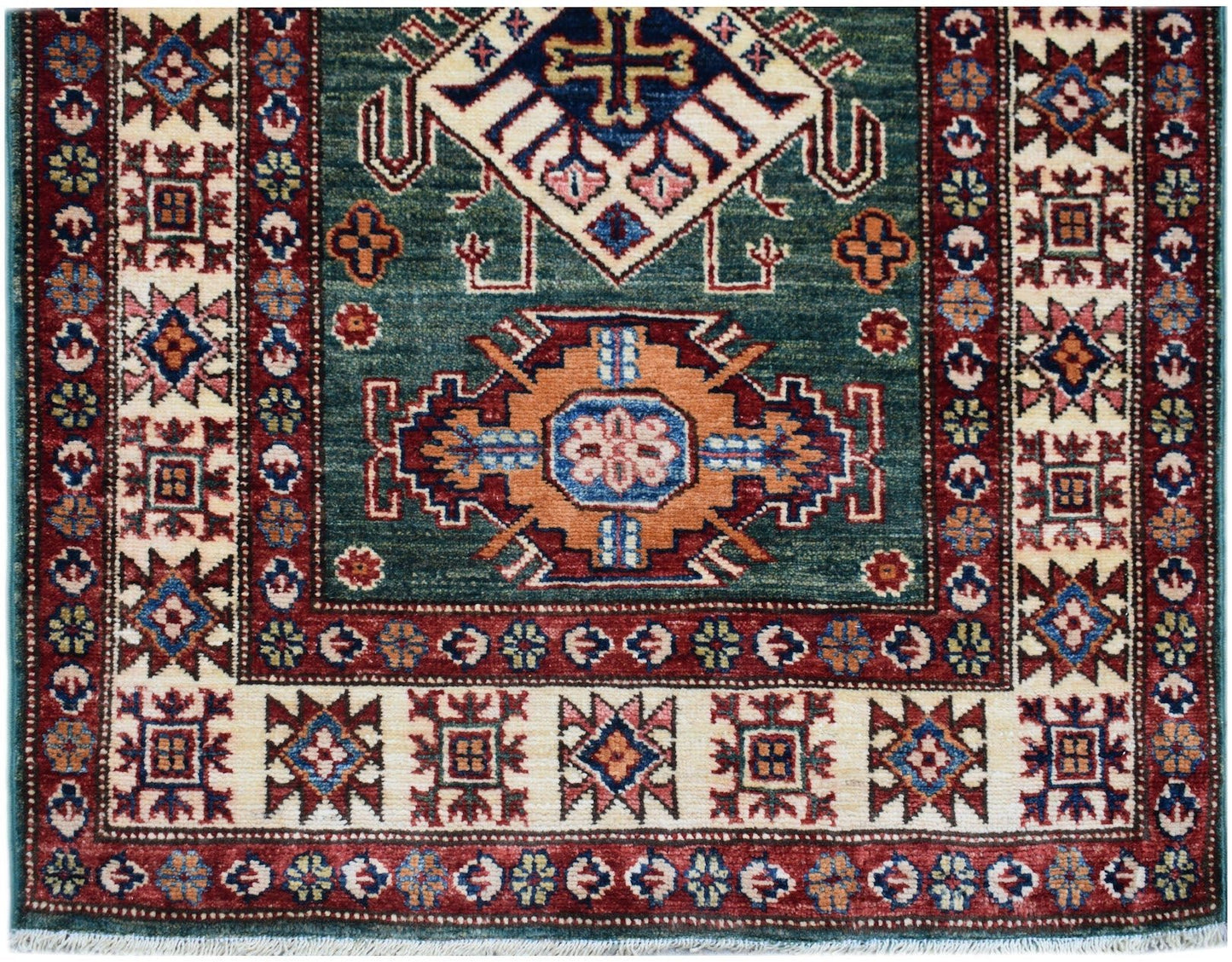 An Afghan Super Kazakh runner rug featuring traditional geometric motifs in red, blue, and cream.