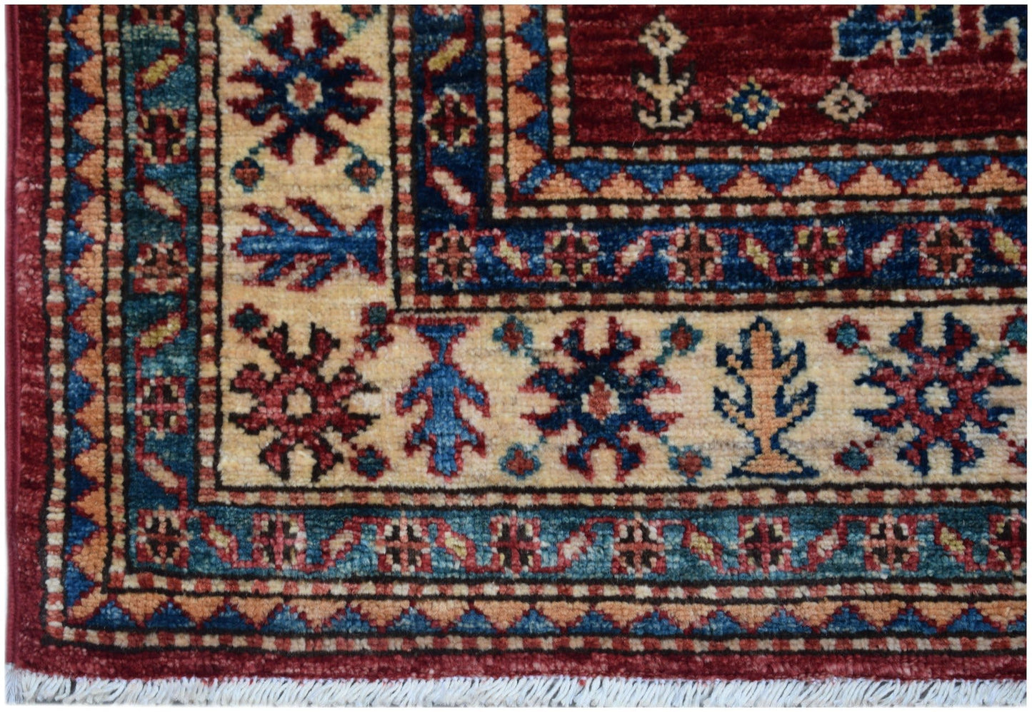 Handmade Afghan Super Kazakh runner featuring traditional geometric motifs in red, blue, and cream.