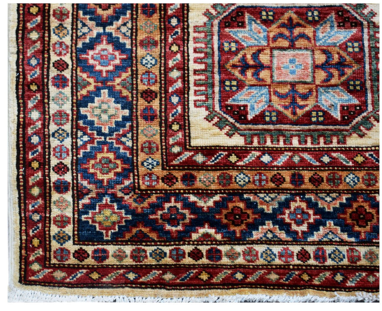 A handmade Afghan Super Kazakh runner featuring traditional geometric motifs in red and blue.
