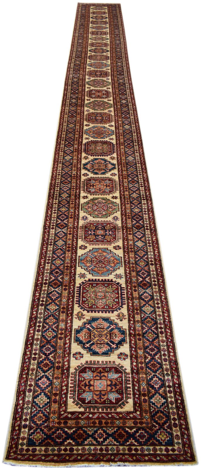 A long, handmade Afghan Super Kazakh runner rug featuring traditional geometric motifs in wool.