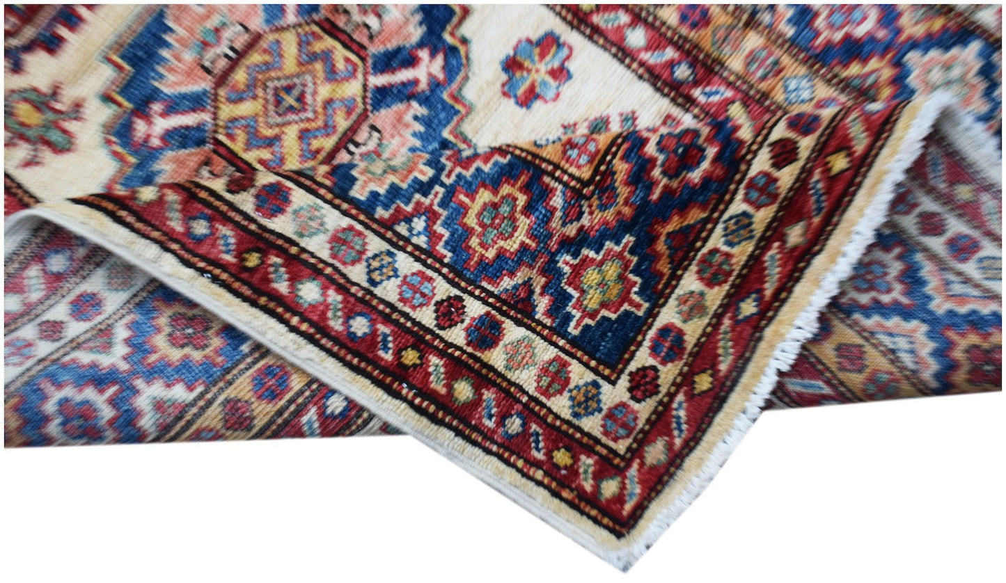 An Afghan Super Kazakh runner featuring traditional geometric motifs in red, blue, and cream.