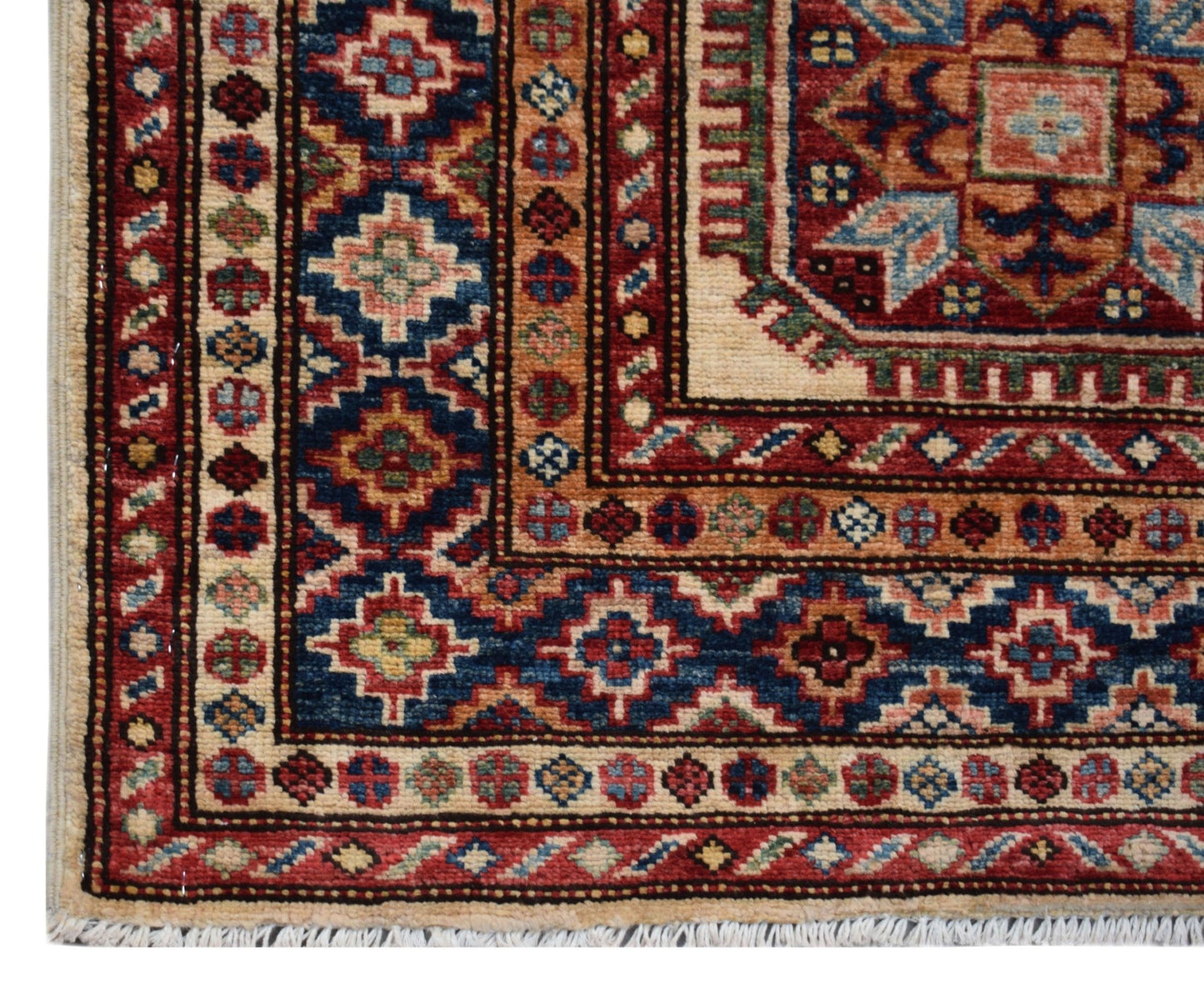 A handmade Afghan Super Kazakh runner featuring traditional geometric motifs in red and blue.