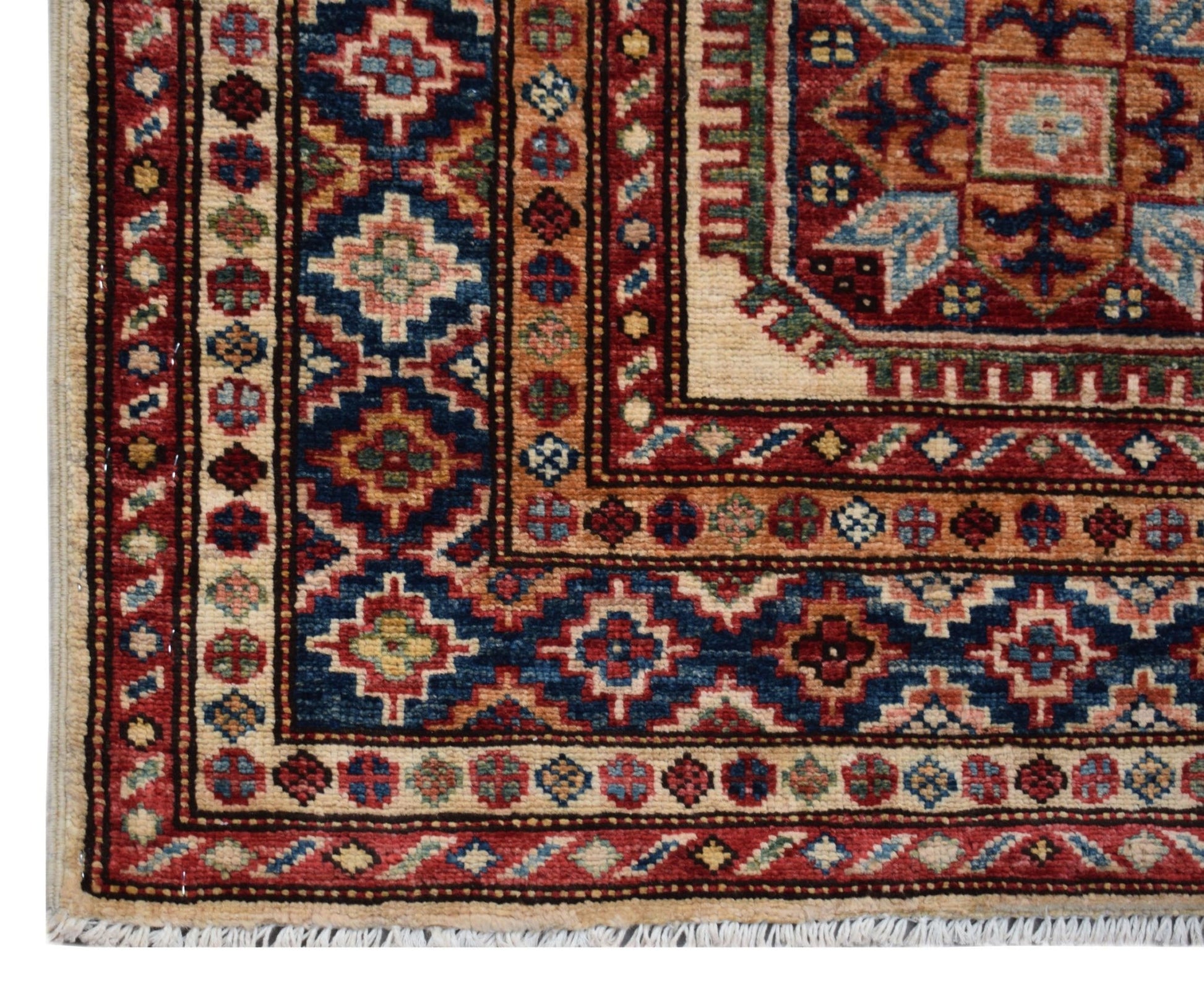 A handmade Afghan Super Kazakh runner featuring traditional geometric motifs in red and blue.