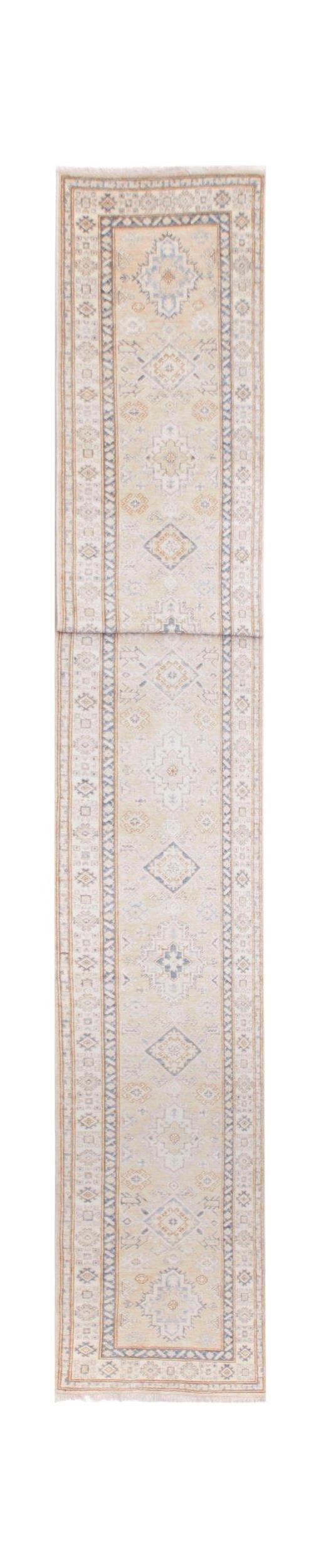 A long, handmade Afghan Super Kazakh runner rug featuring traditional geometric motifs in soft tones.