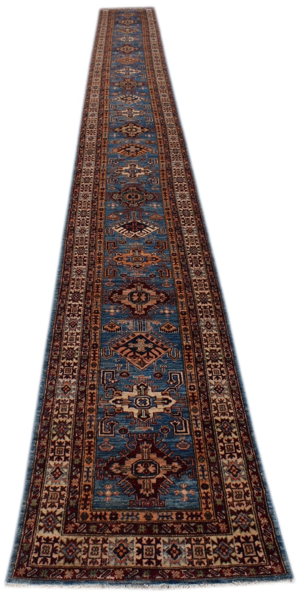 A long, handmade Afghan Super Kazakh runner featuring traditional geometric motifs in blue and red.