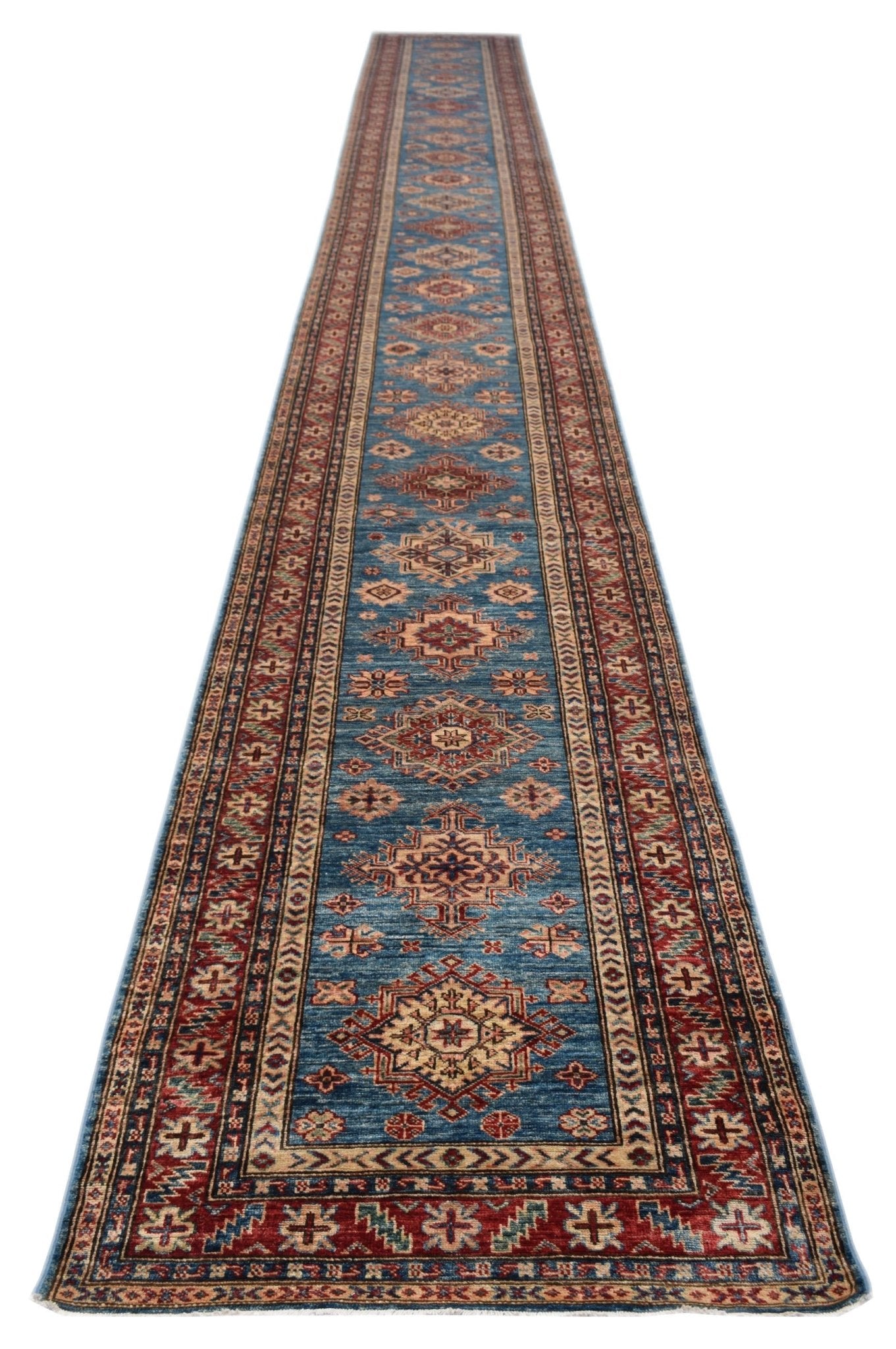 A long, handmade Afghan Super Kazakh runner featuring traditional geometric motifs in blue and red.