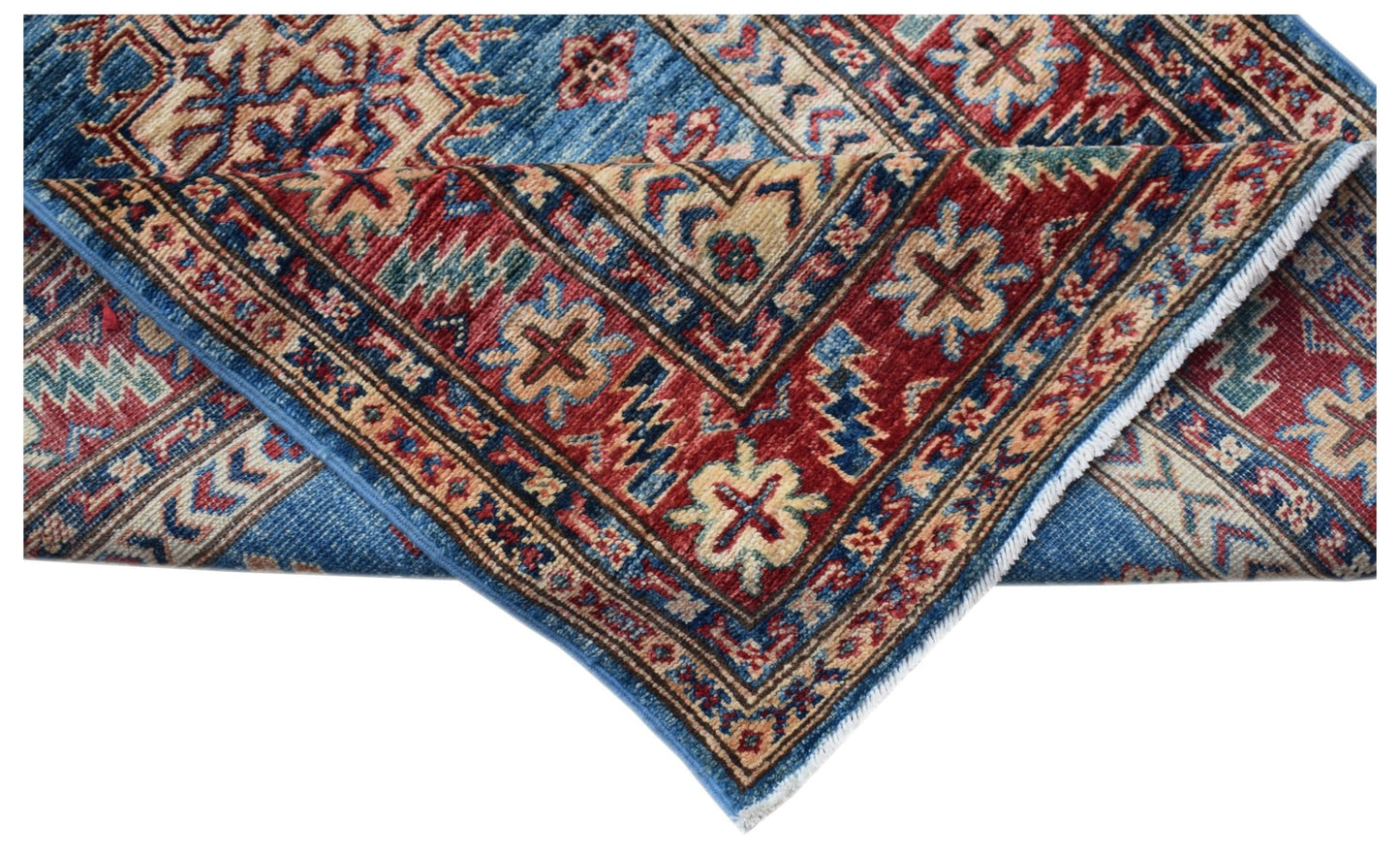 A folded Afghan Super Kazakh runner featuring traditional geometric motifs in red and blue wool.