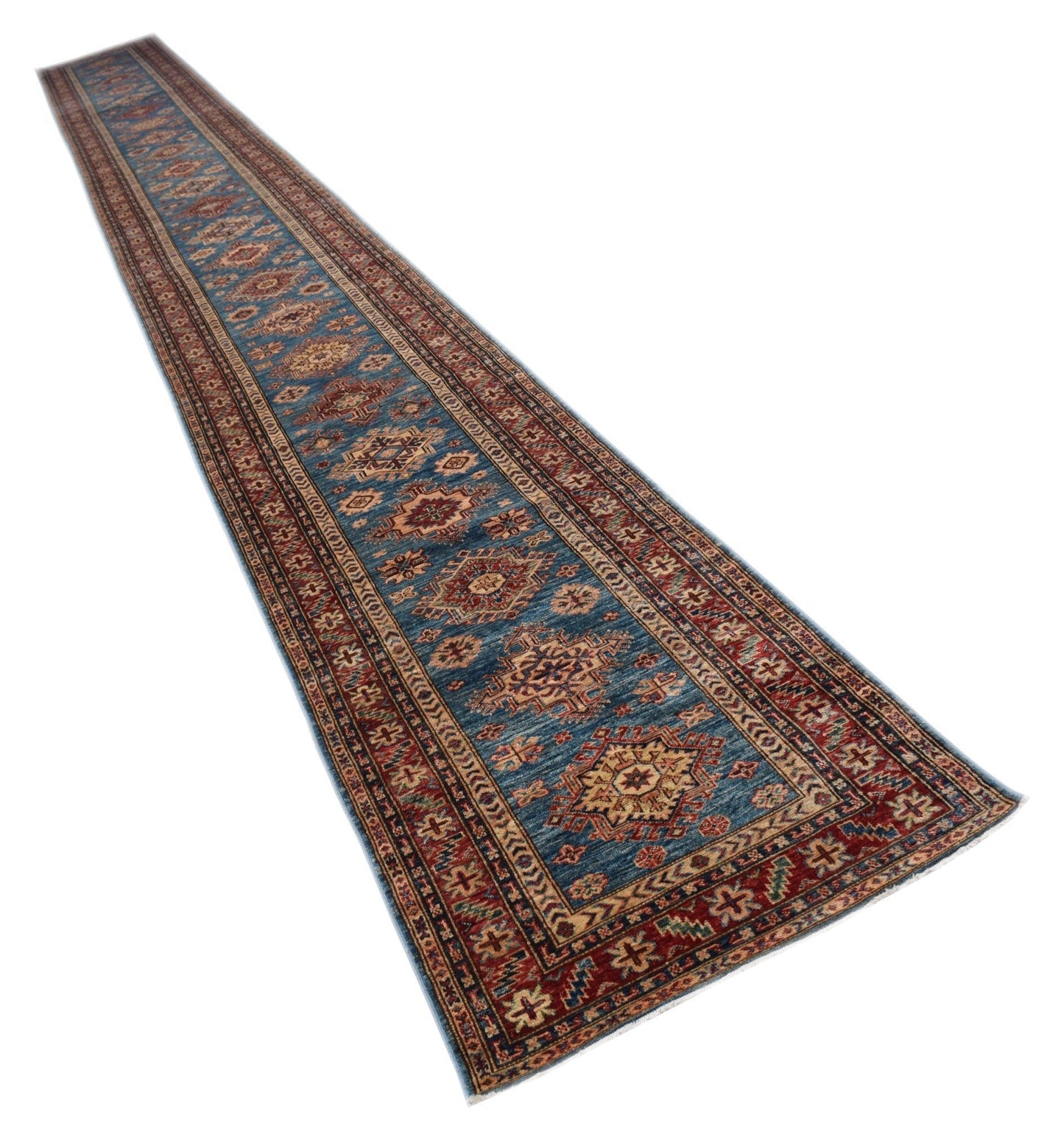 A long, handmade Afghan Super Kazakh runner rug featuring traditional geometric motifs in blue and red.