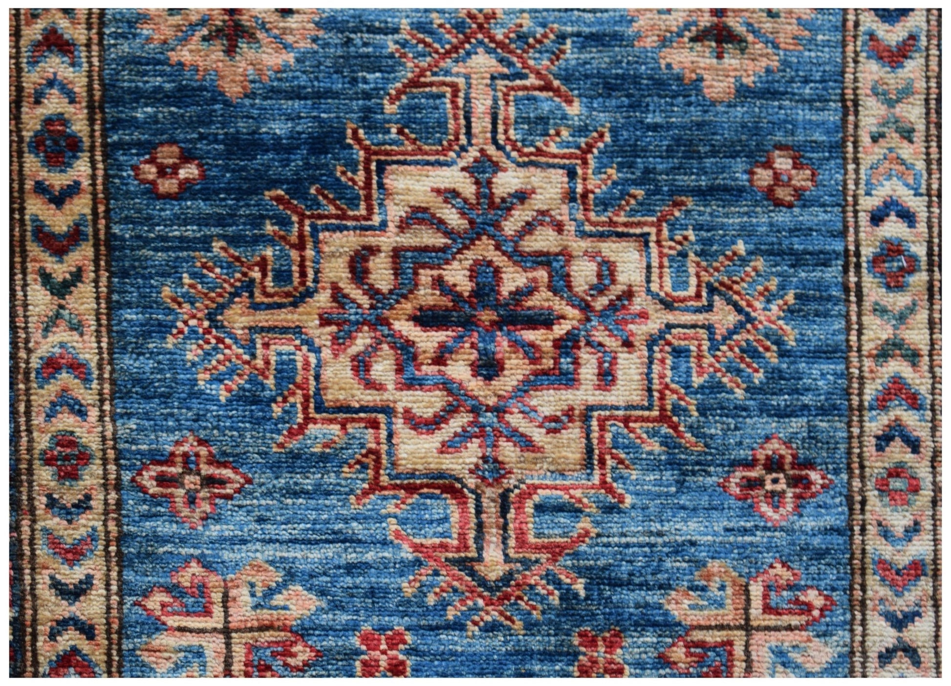 Handmade Afghan Super Kazakh runner featuring a traditional geometric medallion on a blue field.