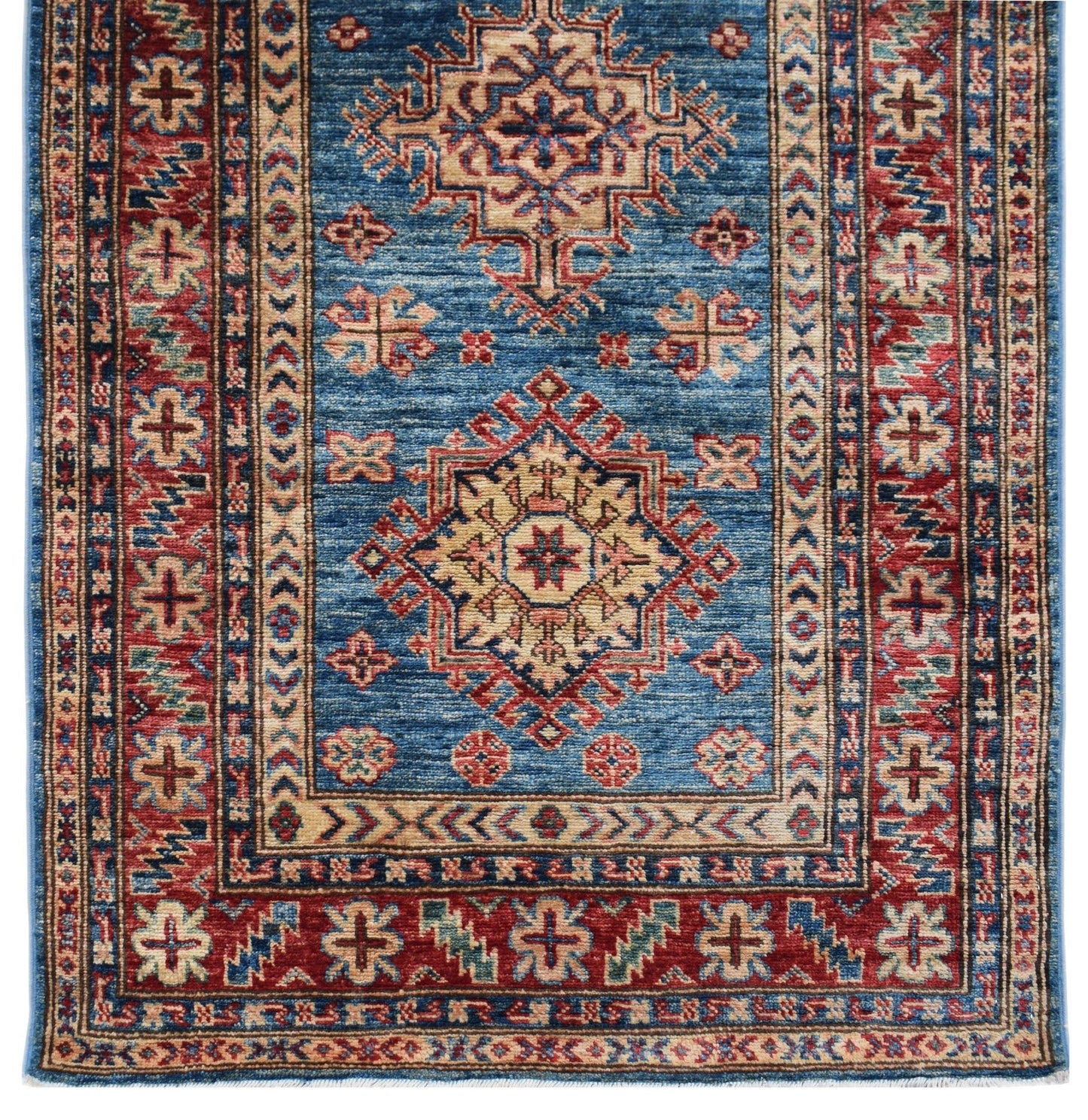 An Afghan Super Kazakh runner rug featuring traditional geometric motifs in blue, red, and cream.