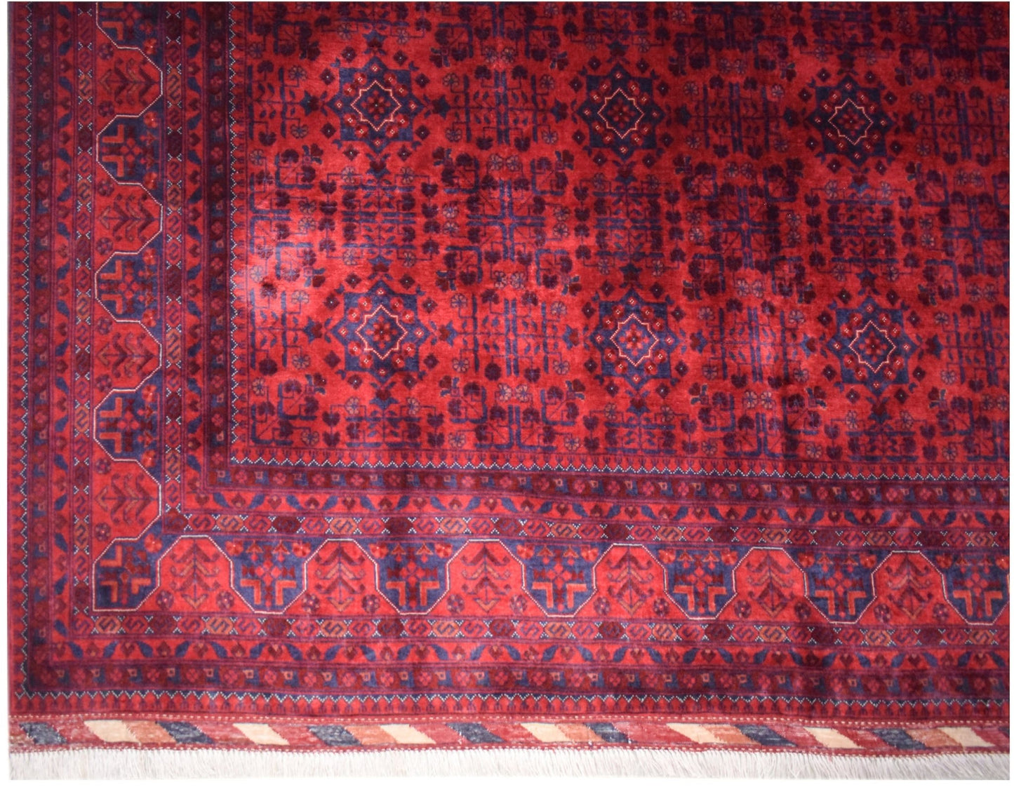 Handmade Afghan Biljik rug featuring a deep red field with intricate blue geometric patterns.