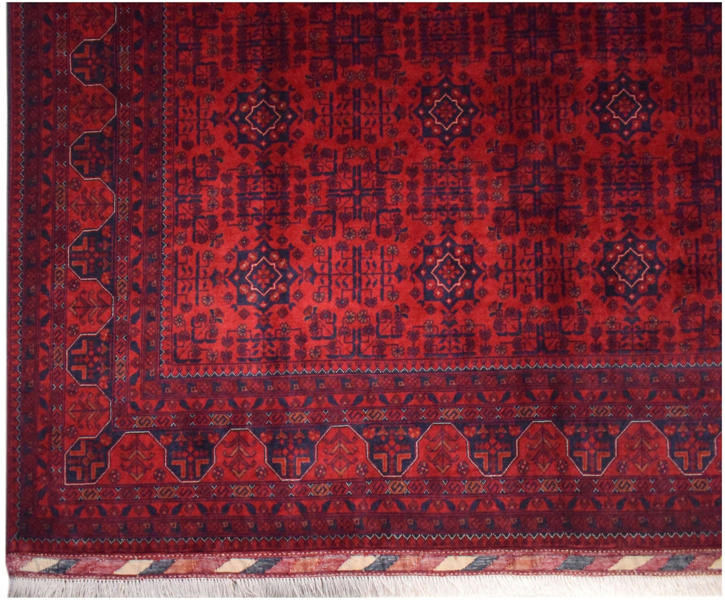 An Afghan Biljik rug featuring a deep red field with intricate blue geometric patterns and borders.