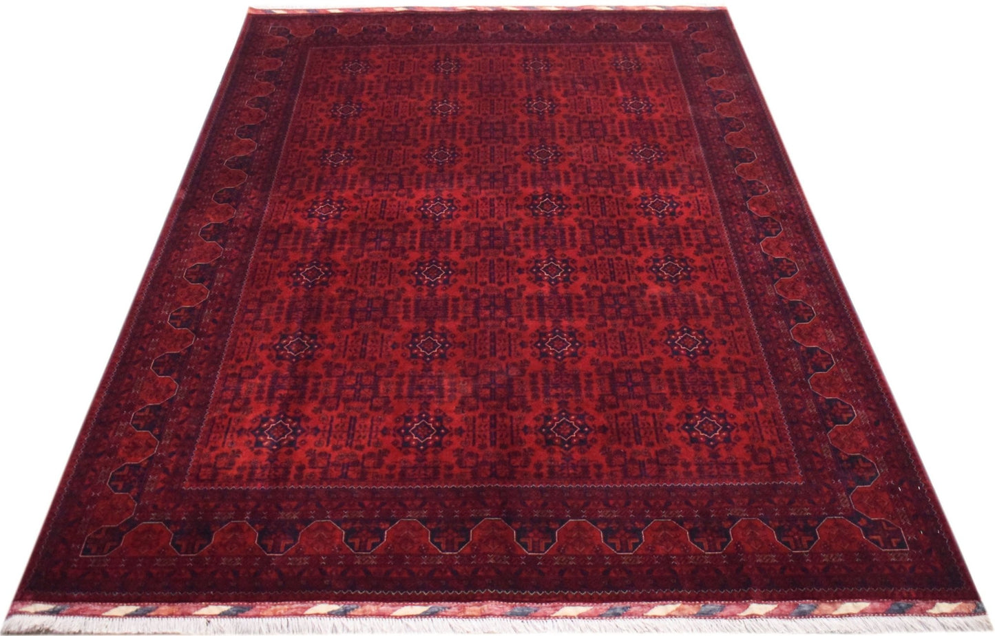 A handmade Afghan Biljik rug featuring a deep red field with intricate blue geometric patterns.