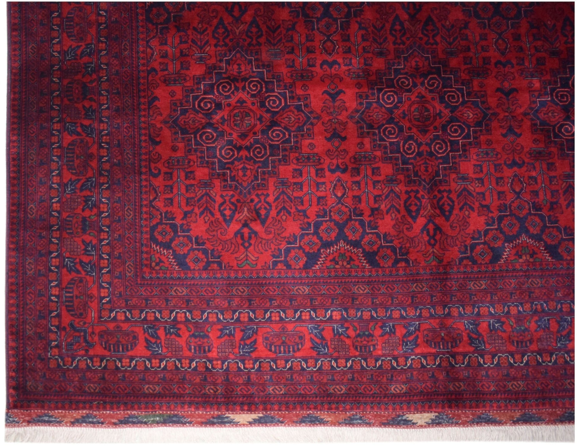 A handmade Afghan Biljik wool rug featuring intricate geometric patterns in deep red and blue.