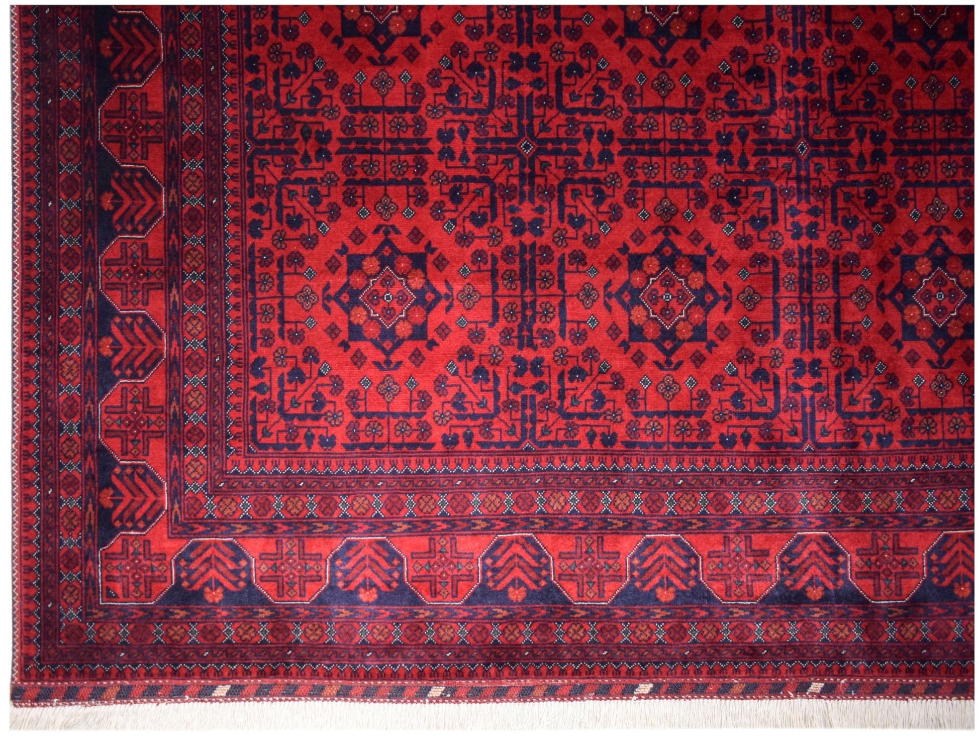 An Afghan Biljik rug featuring a deep red field with intricate blue geometric patterns and borders.
