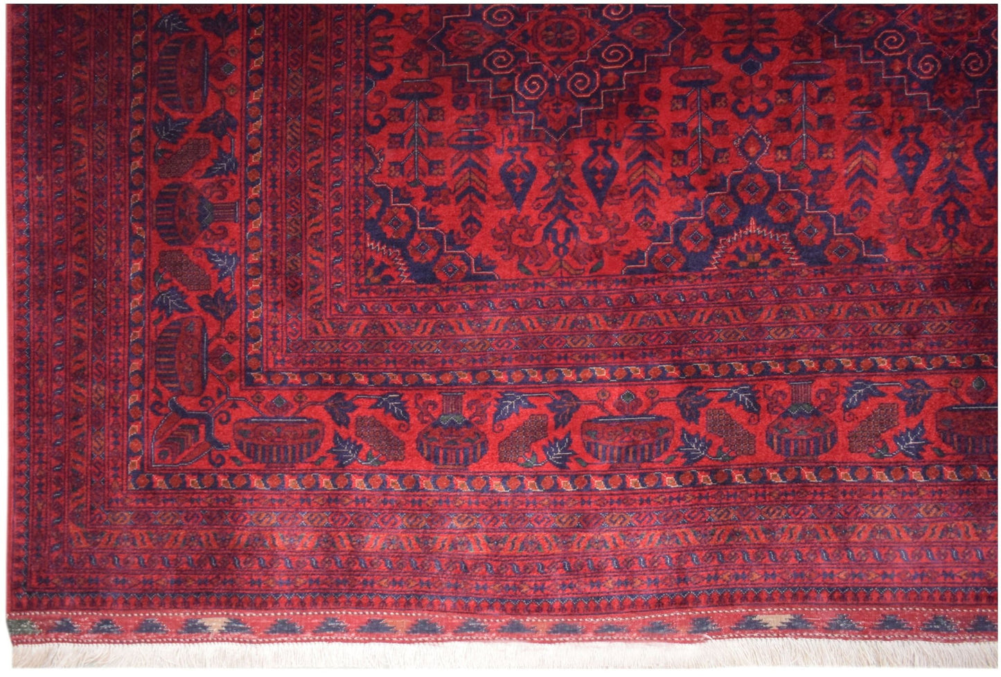 Handmade Afghan Biljik rug featuring intricate geometric patterns in deep red and blue wool.
