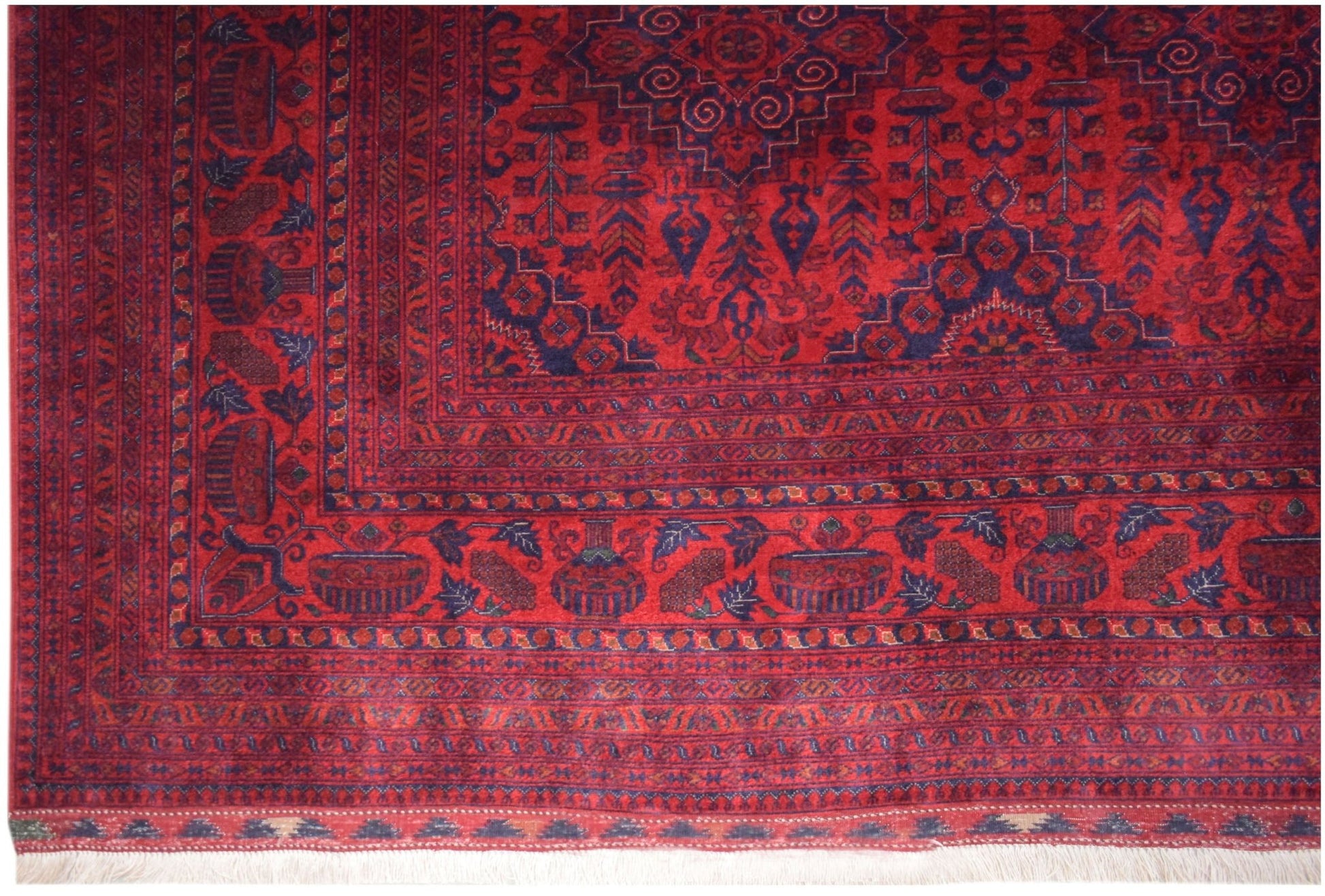 Handmade Afghan Biljik rug featuring intricate geometric patterns in deep red and blue wool.