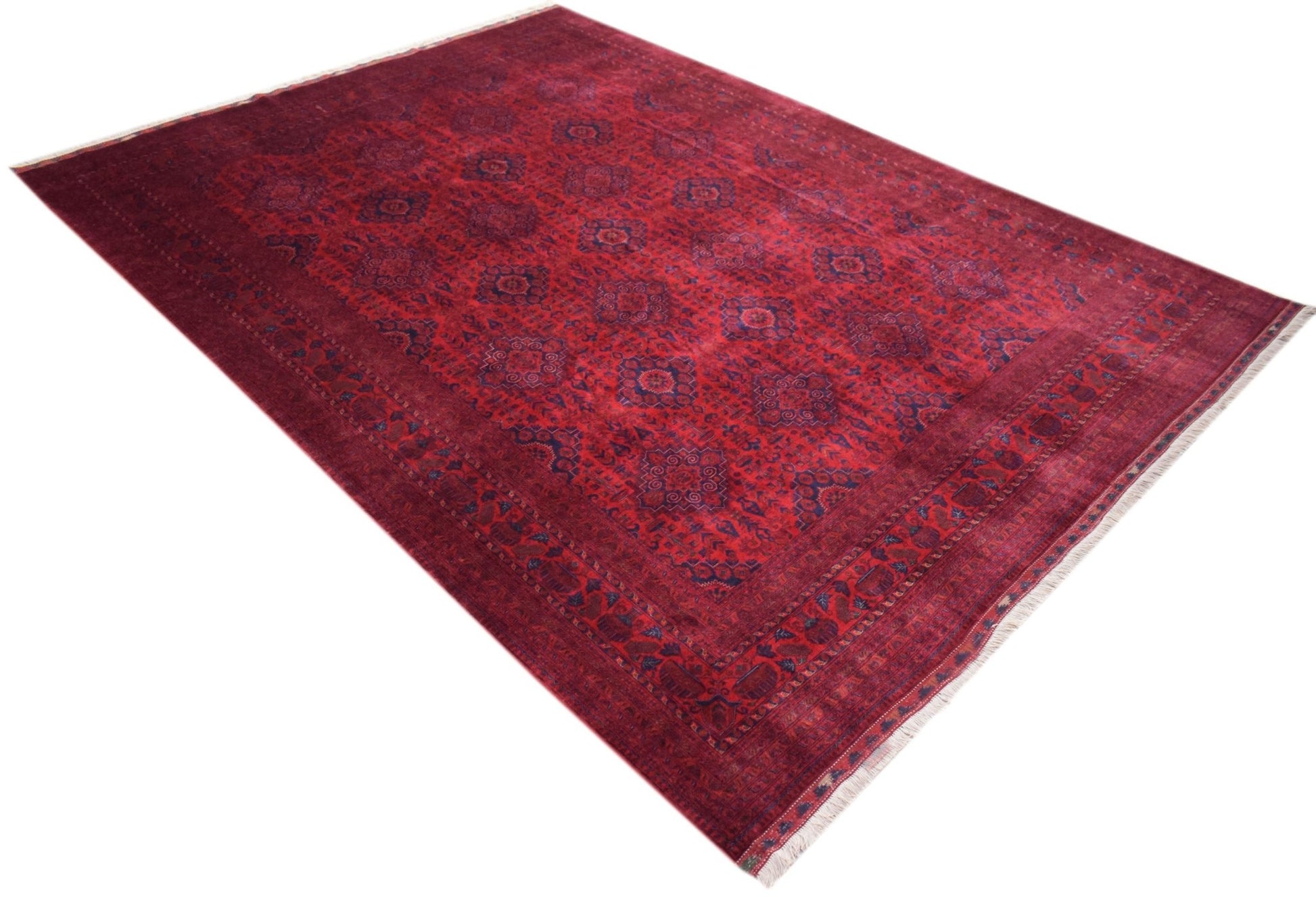 An Afghan Biljik rug featuring a deep red field with intricate blue geometric patterns.