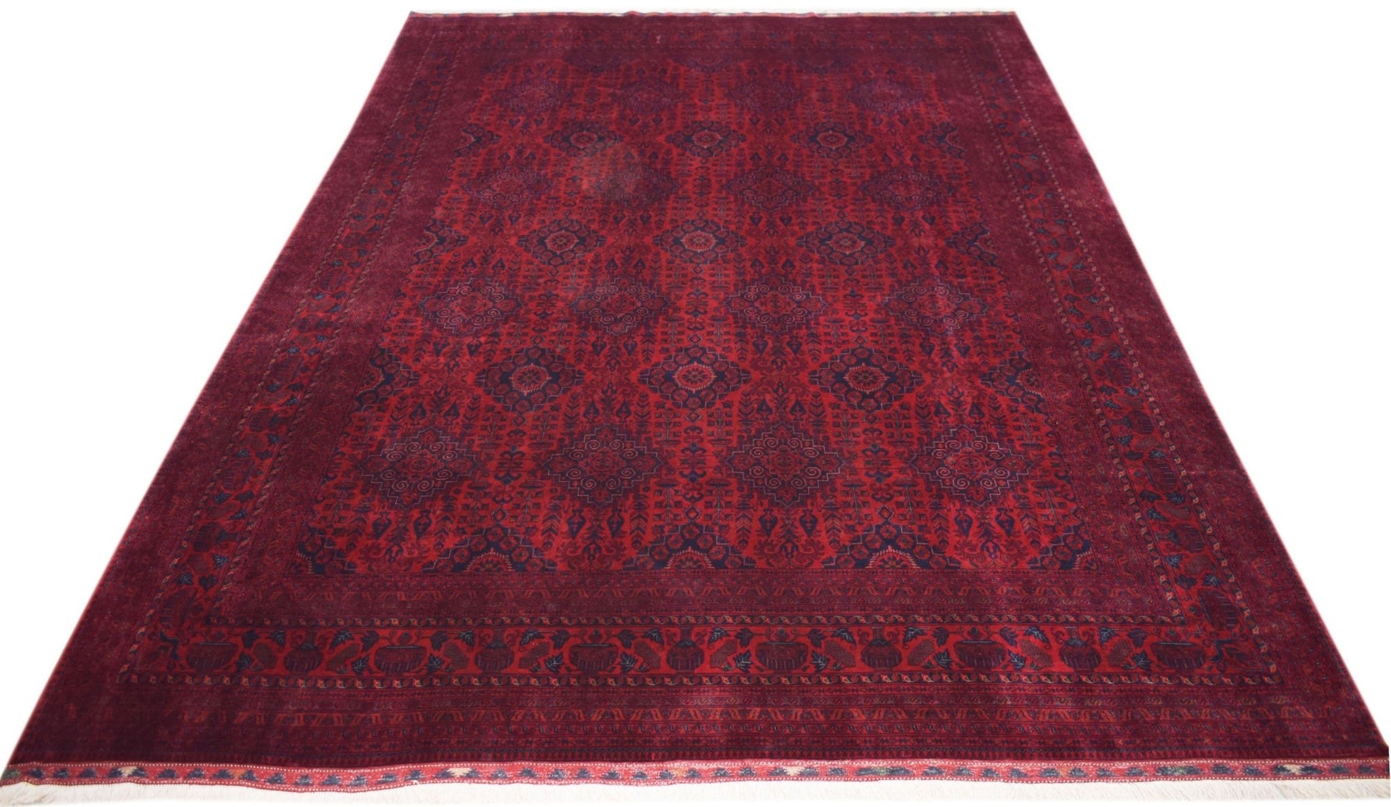 A handmade Afghan Biljik rug featuring a deep red field with intricate blue geometric patterns.