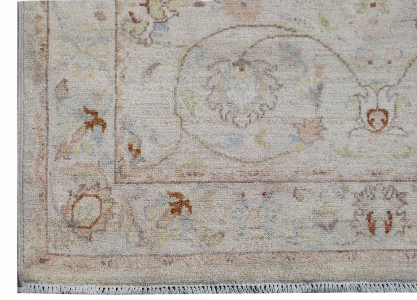 A handmade Afghan Chobi rug featuring traditional floral patterns in soft, earthy tones.
